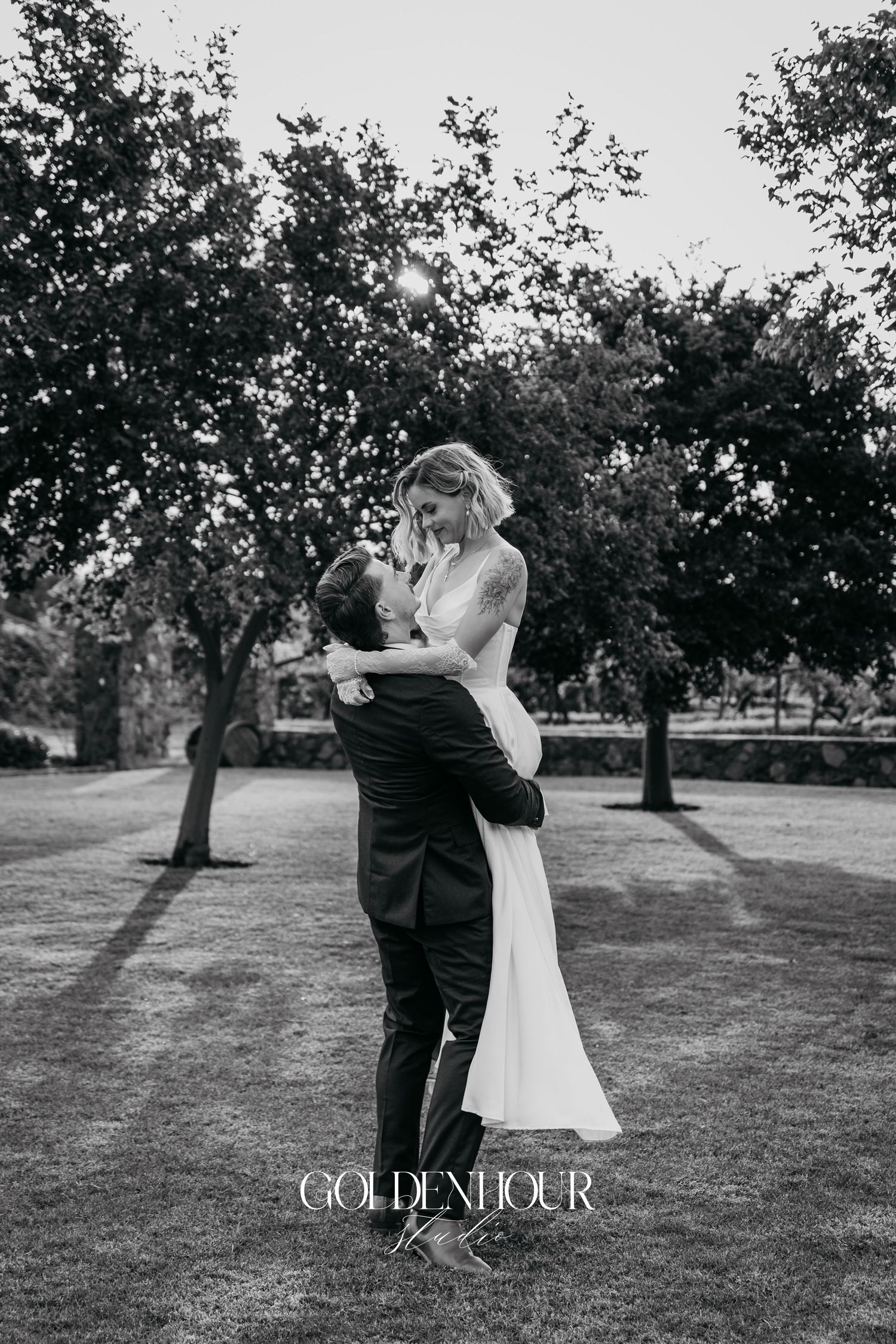 Romantic black and white wedding dance photos captured in an orchard setting.