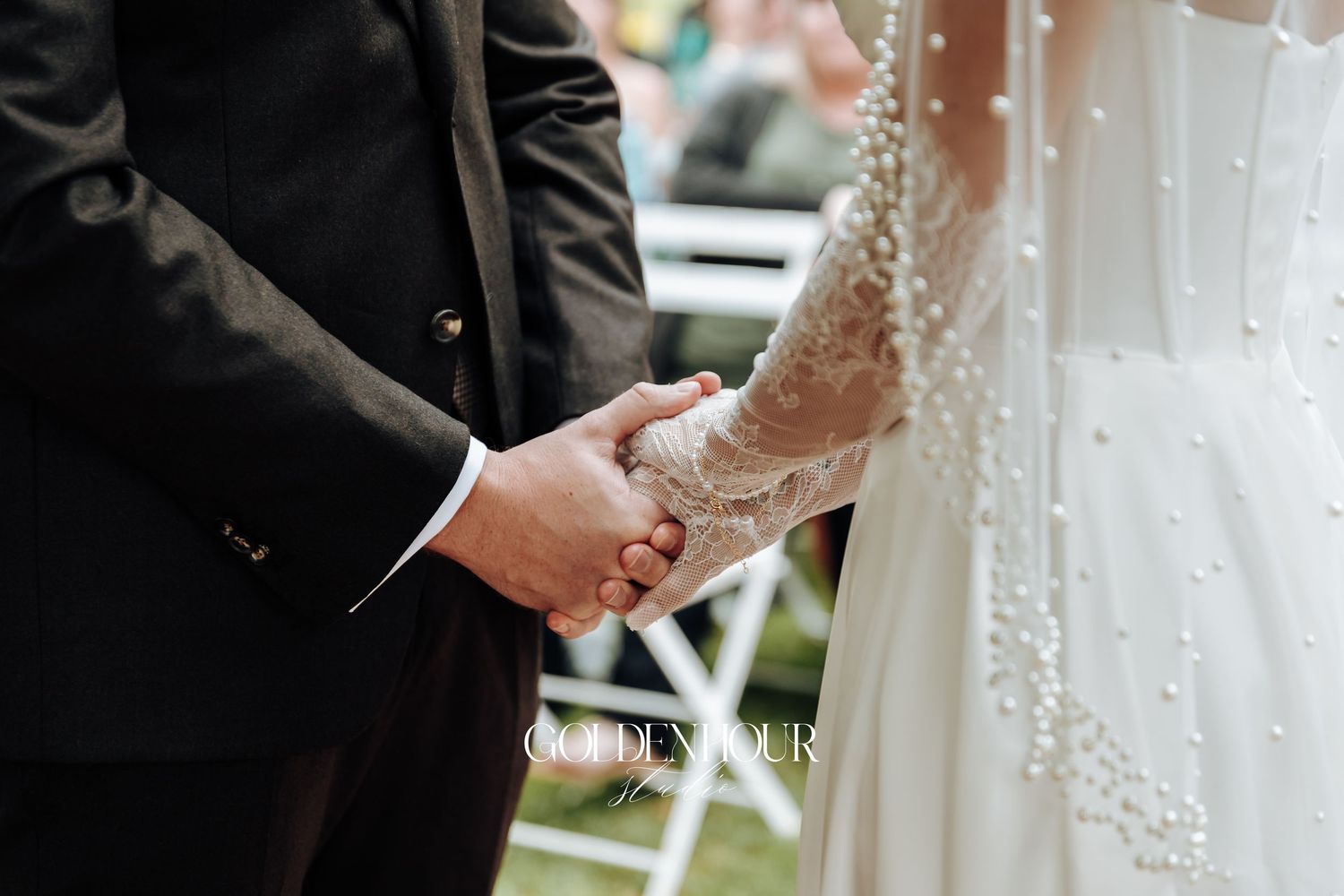 Close-up of hands exchanging rings during wedding ceremony.