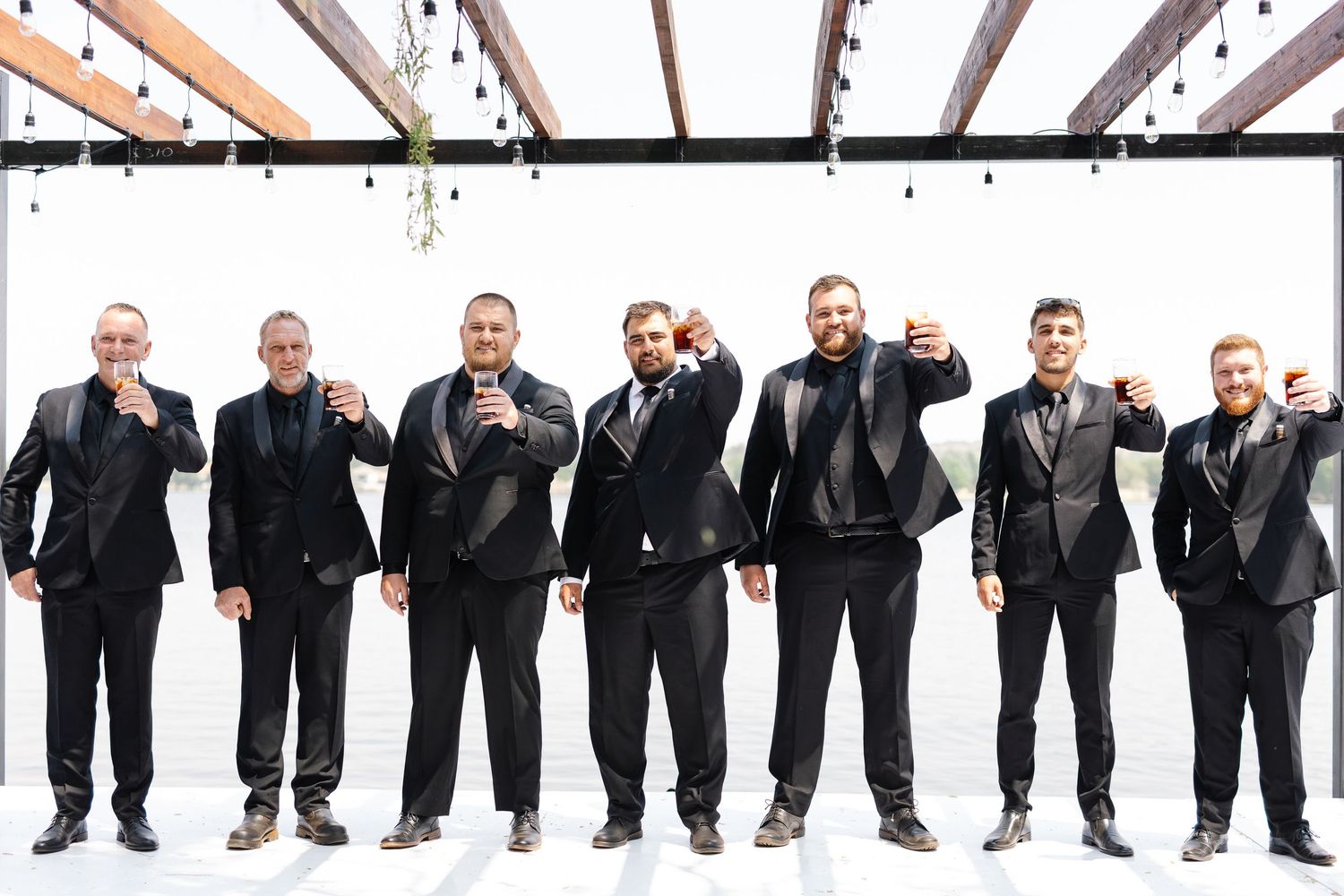 A creative panoramic sequence showing a group of people in black suits posing and jumping in progressive motion.