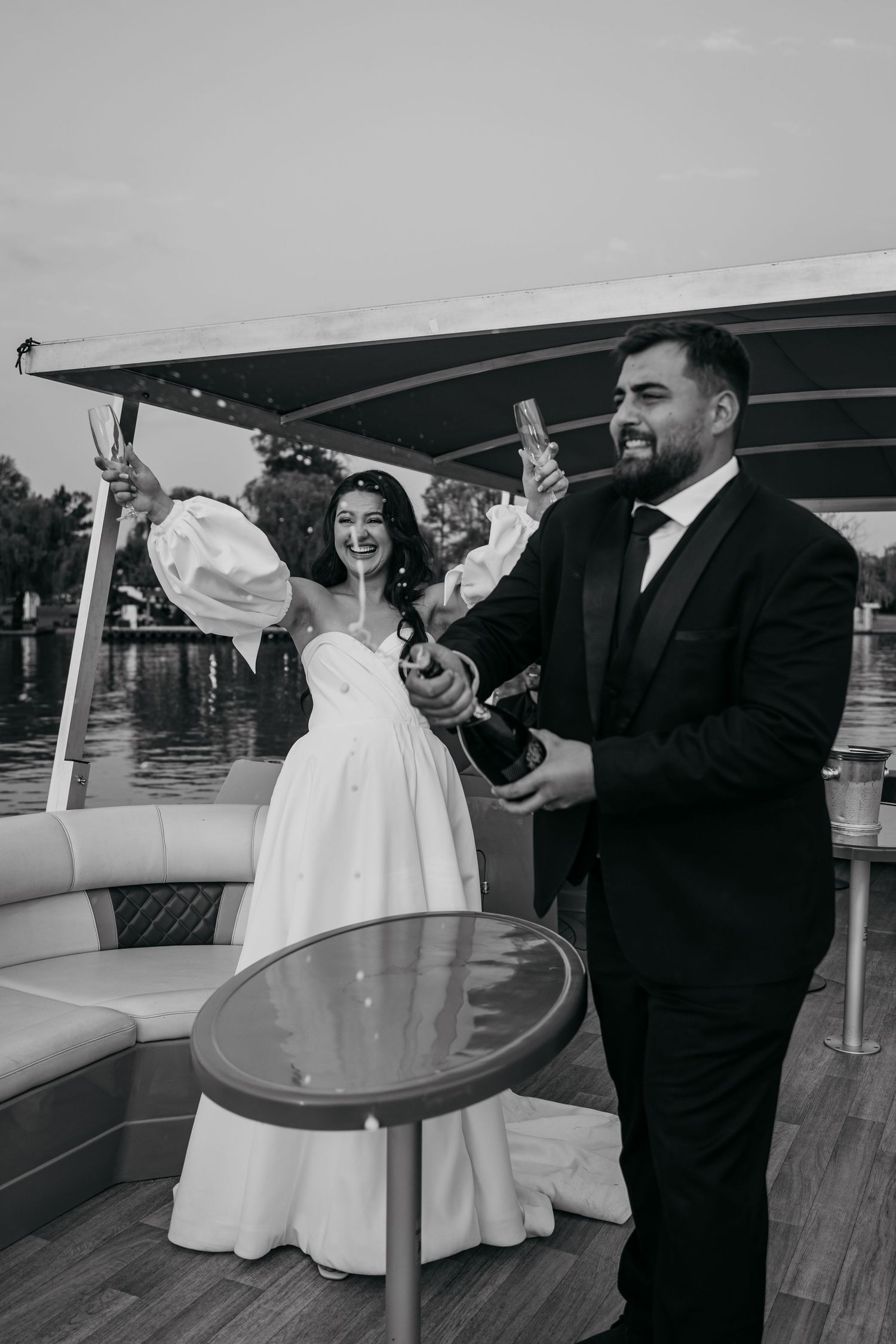 A couple dances together on a boat deck during what appears to be a celebration or special event.