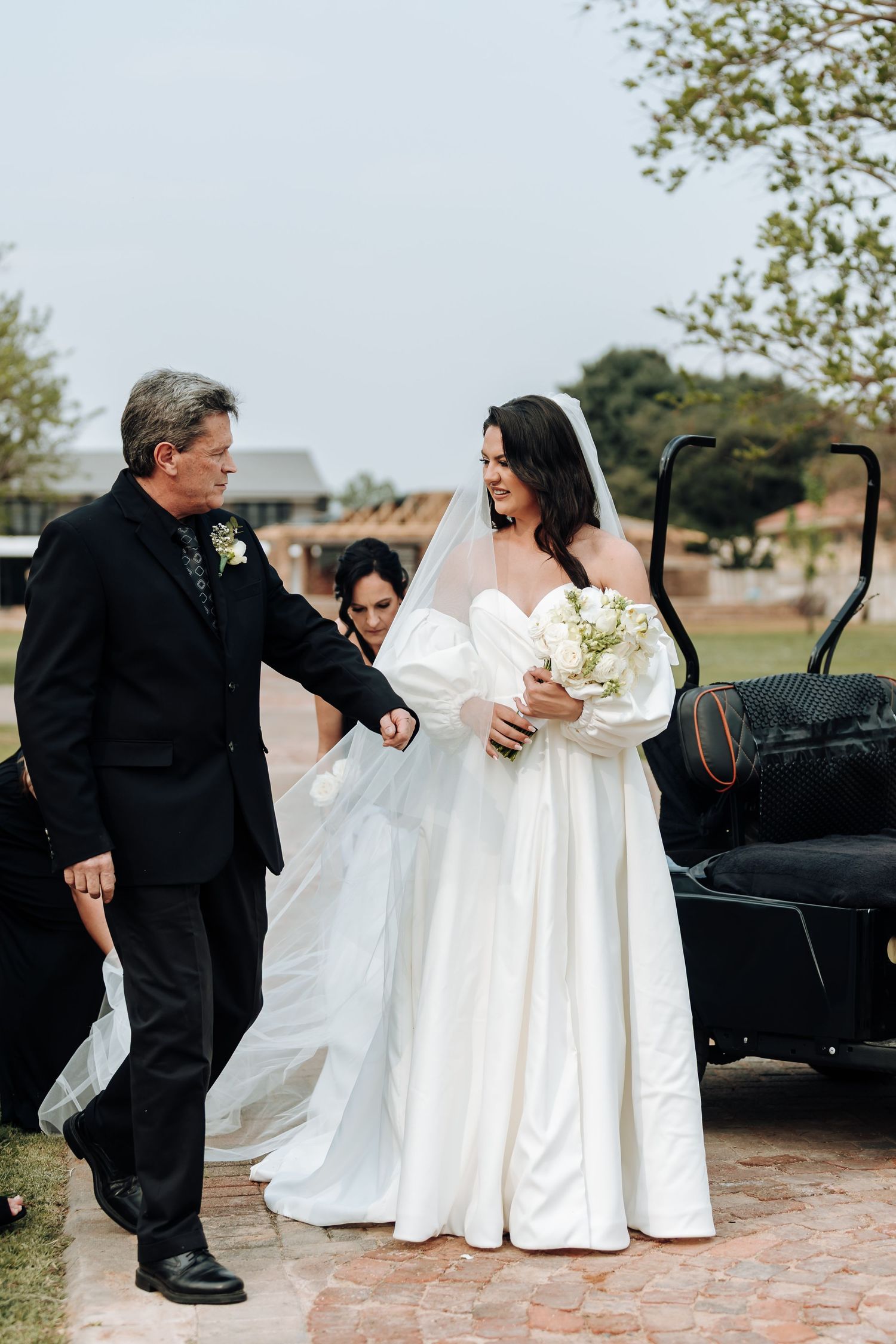 A series of wedding photos showing a bride in white dress and someone in black attire interacting outdoors.