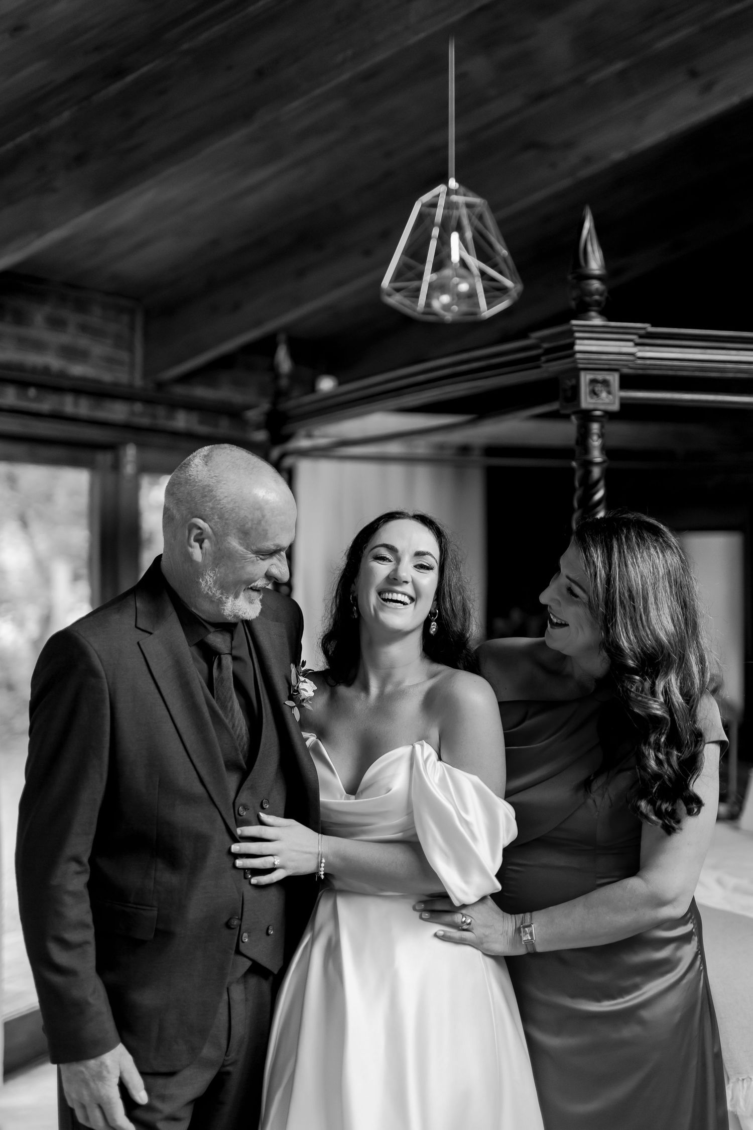 Black and white series showing joyful candid moments between people during a wedding celebration.