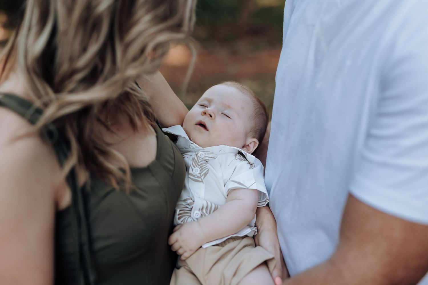 Sweet intimate family portraits captured in black and white showing loving interactions between parents and baby.