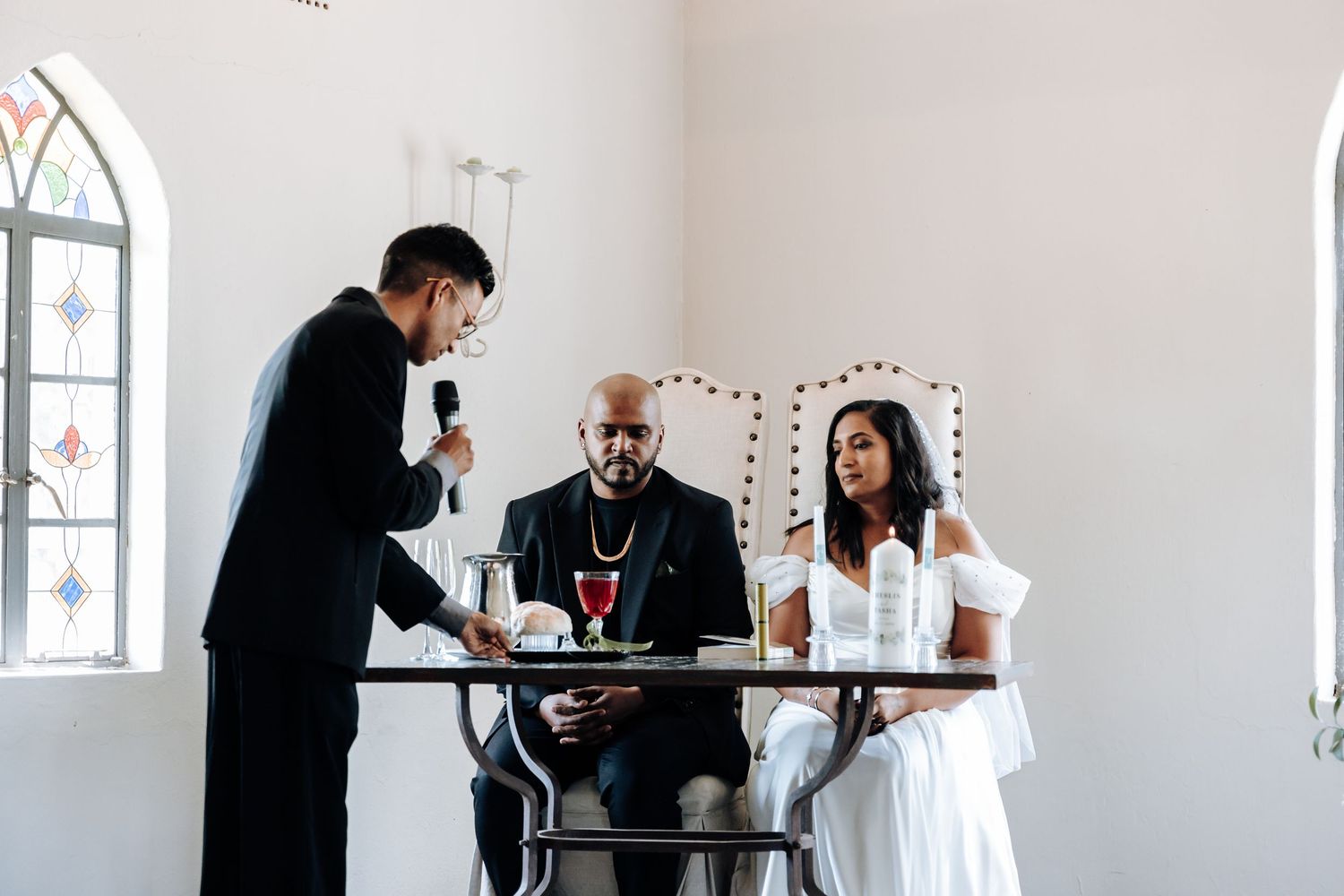 Wedding ceremony signing with couple at altar in bright church interior.