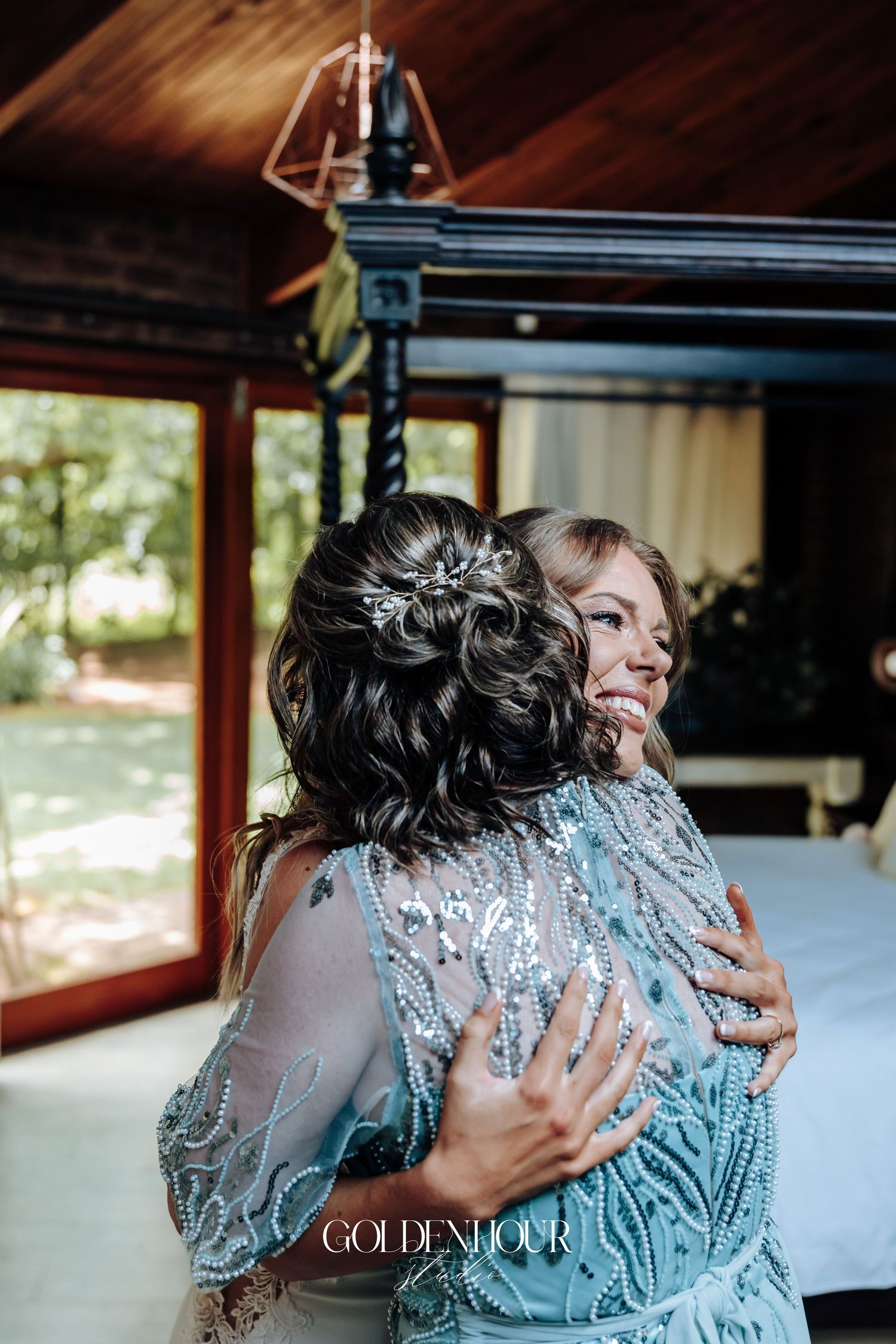 Emotional embrace between two people wearing sparkling formal attire.