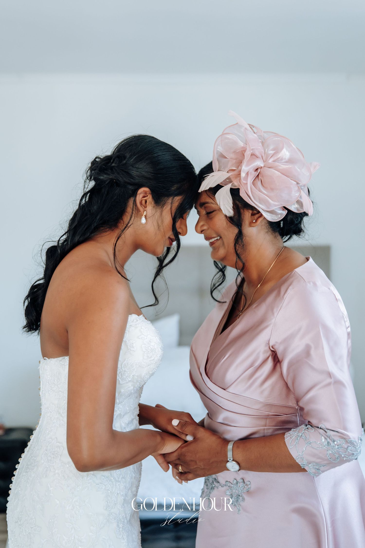 Intimate moments shared between two people in soft pink and white attire.