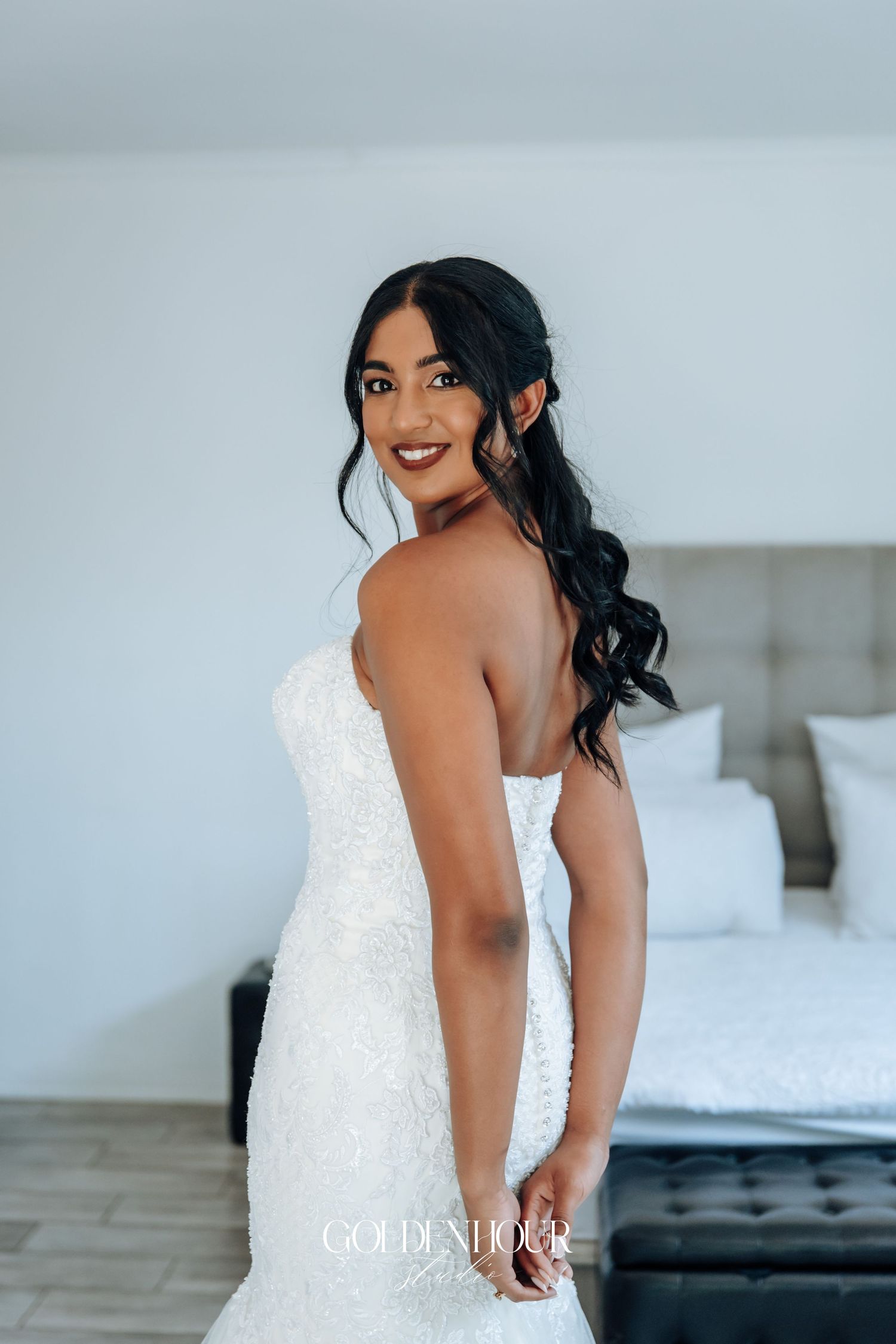 Elegant white lace wedding dress with fitted silhouette shown from back view.