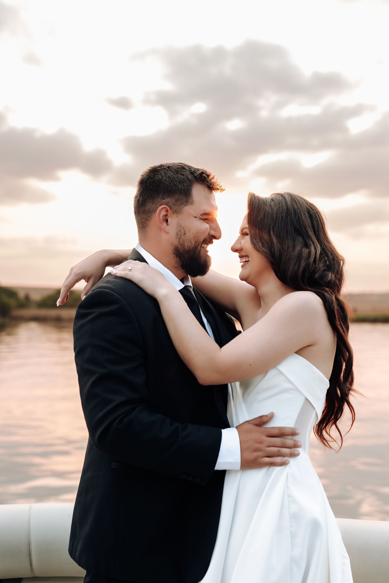 A romantic sunset photoshoot shows a couple embracing in multiple tender moments on a beach.