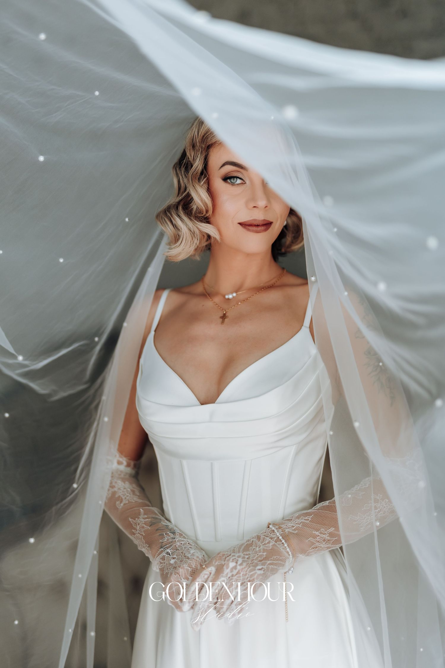 Close-up of flowing white wedding veil with delicate lace details.