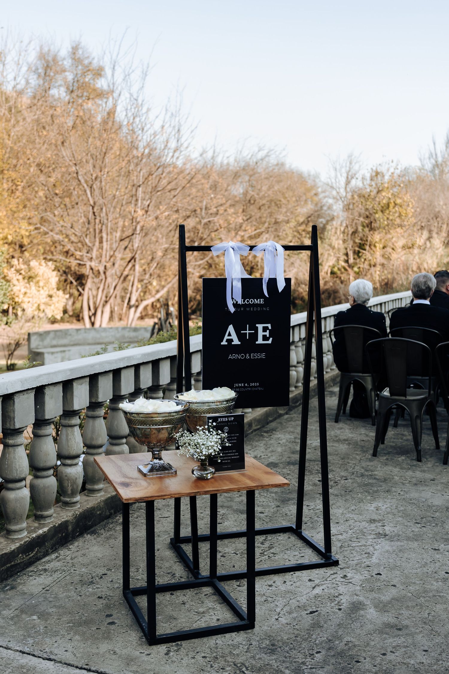 A series of garden vignettes showing rustic outdoor seating with black steel furniture and wooden table on pebbled ground.