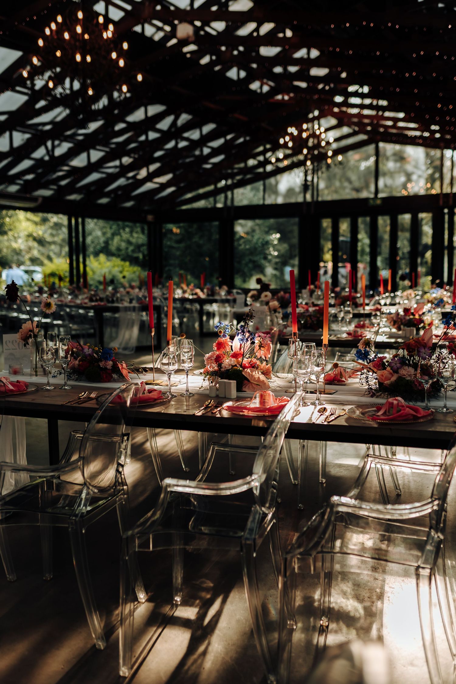Wedding reception venue with elegant table settings and string lights creating a romantic atmosphere.