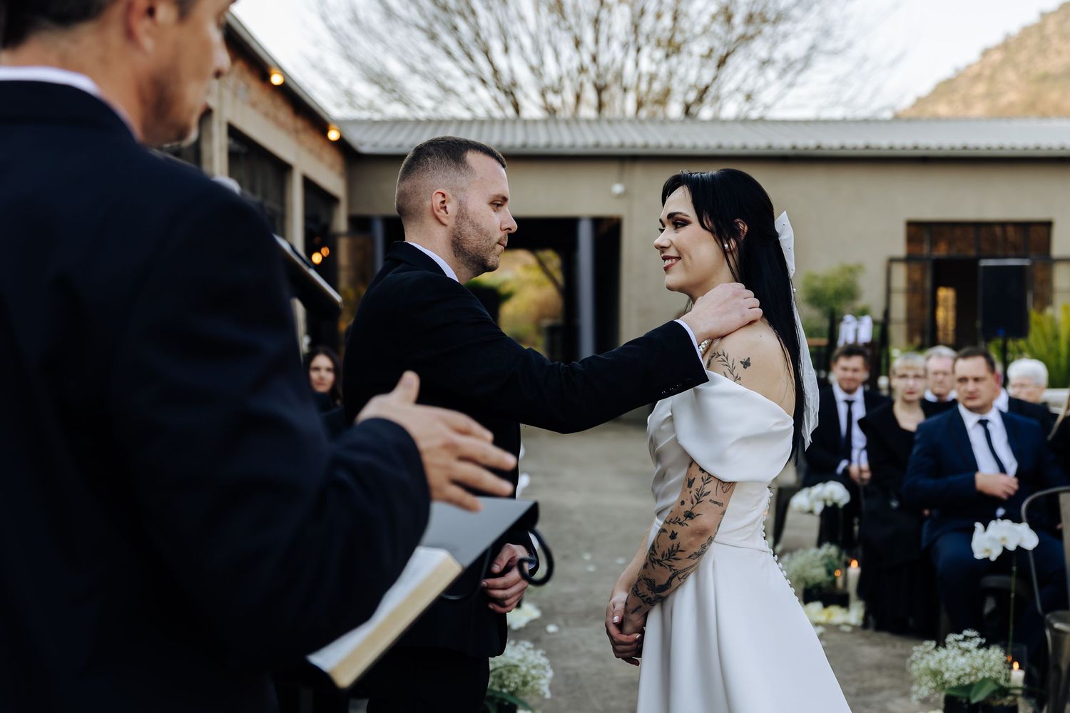 Newlywed couple shares intimate dance moments at an outdoor wedding reception venue.