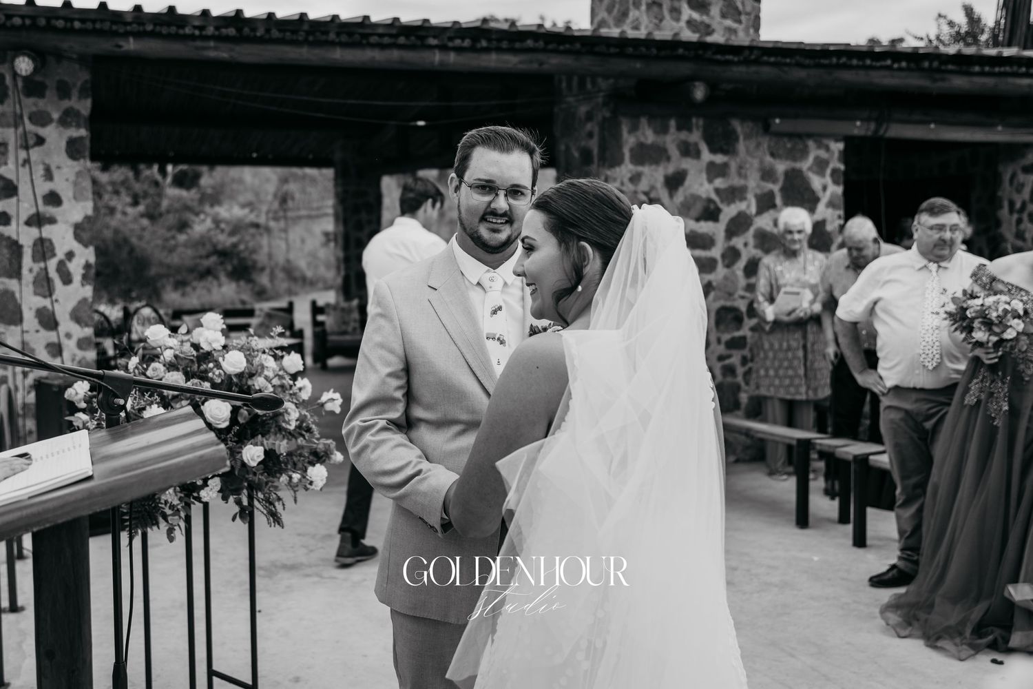 Black and white wedding reception moments at a rustic stone venue.