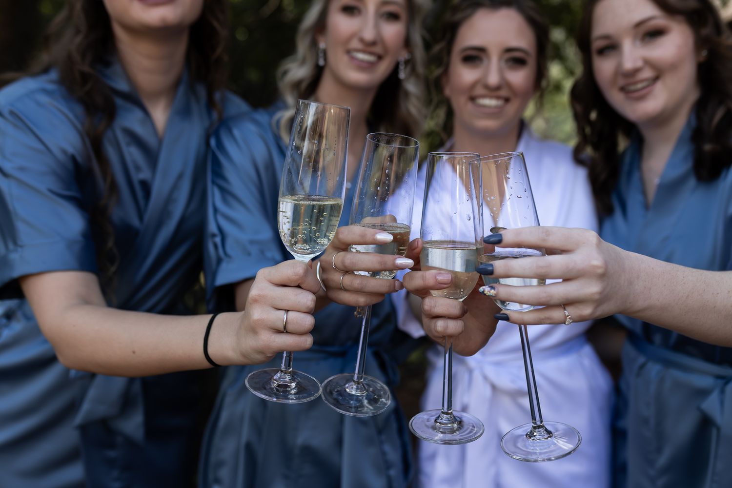 Close up of champagne glasses clinking together in a celebratory toast.