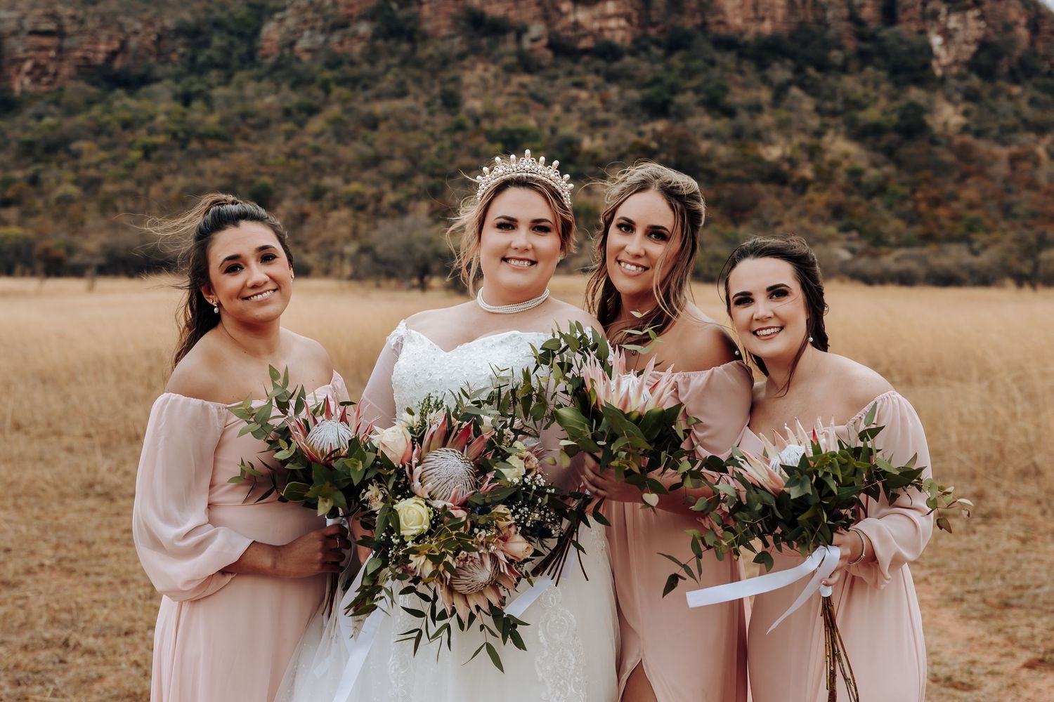 A collection of candid wedding photos showing bridal party members in pink dresses holding bouquets in a desert landscape.