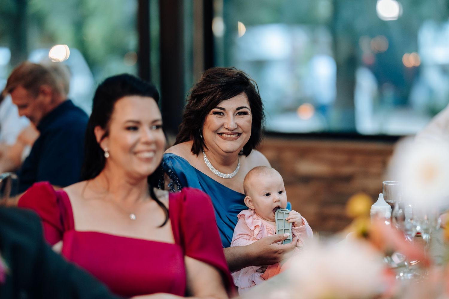 Wedding guests enjoying drinks and conversation at an outdoor reception venue.