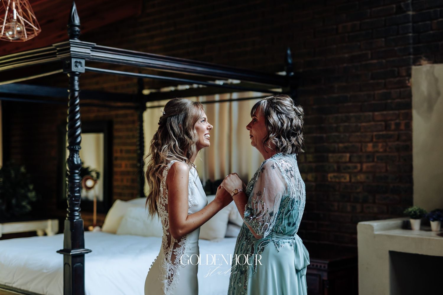 Intimate wedding reception moment in a rustic brick-walled venue.