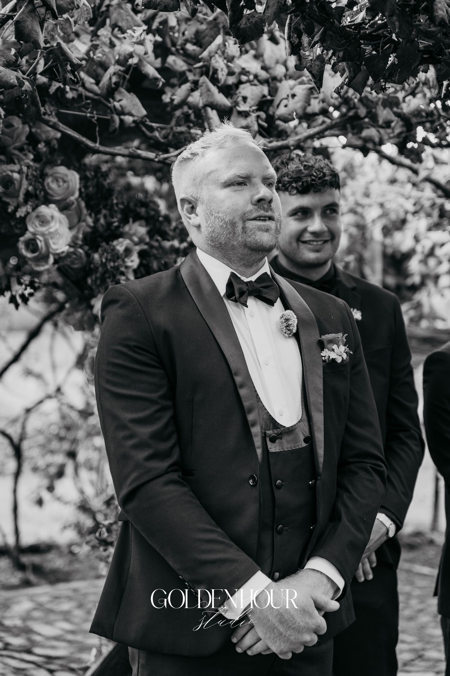 Black and white wedding photo series showing joyful moments between two people in formal attire under tree branches.