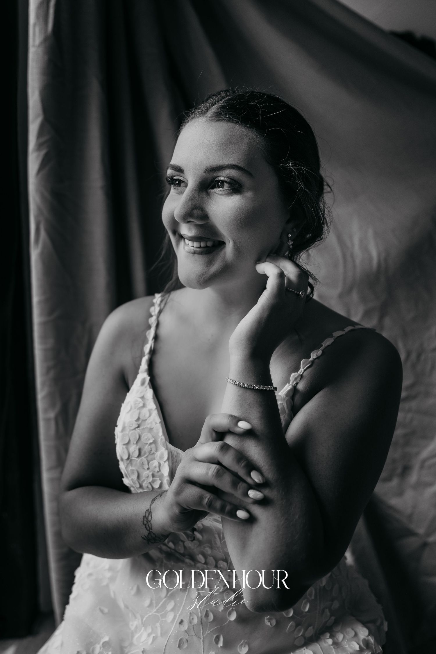 Artistic black and white bridal portrait showing delicate lace details.