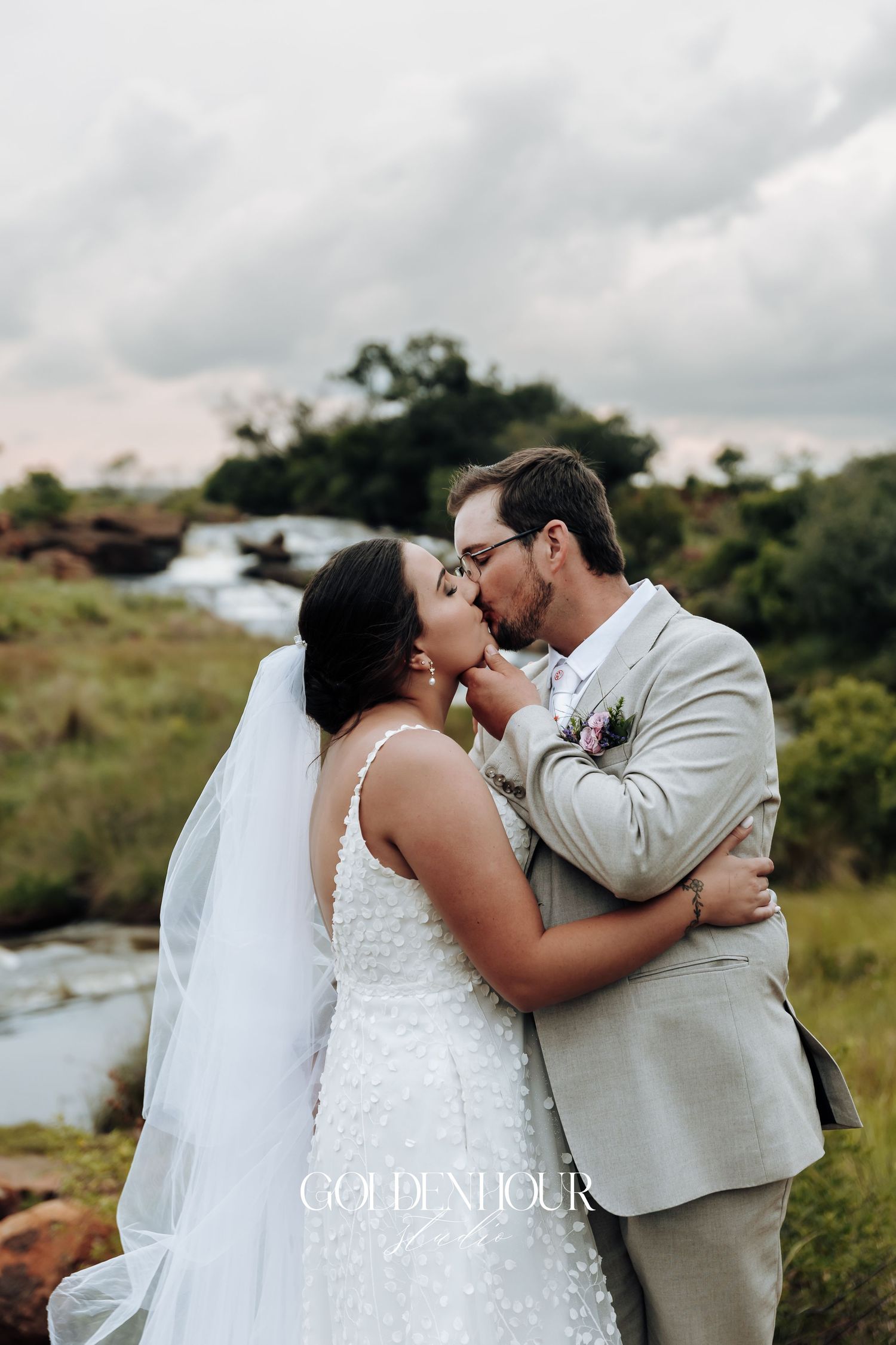 Romantic wedding couple shares intimate moments in an outdoor setting.