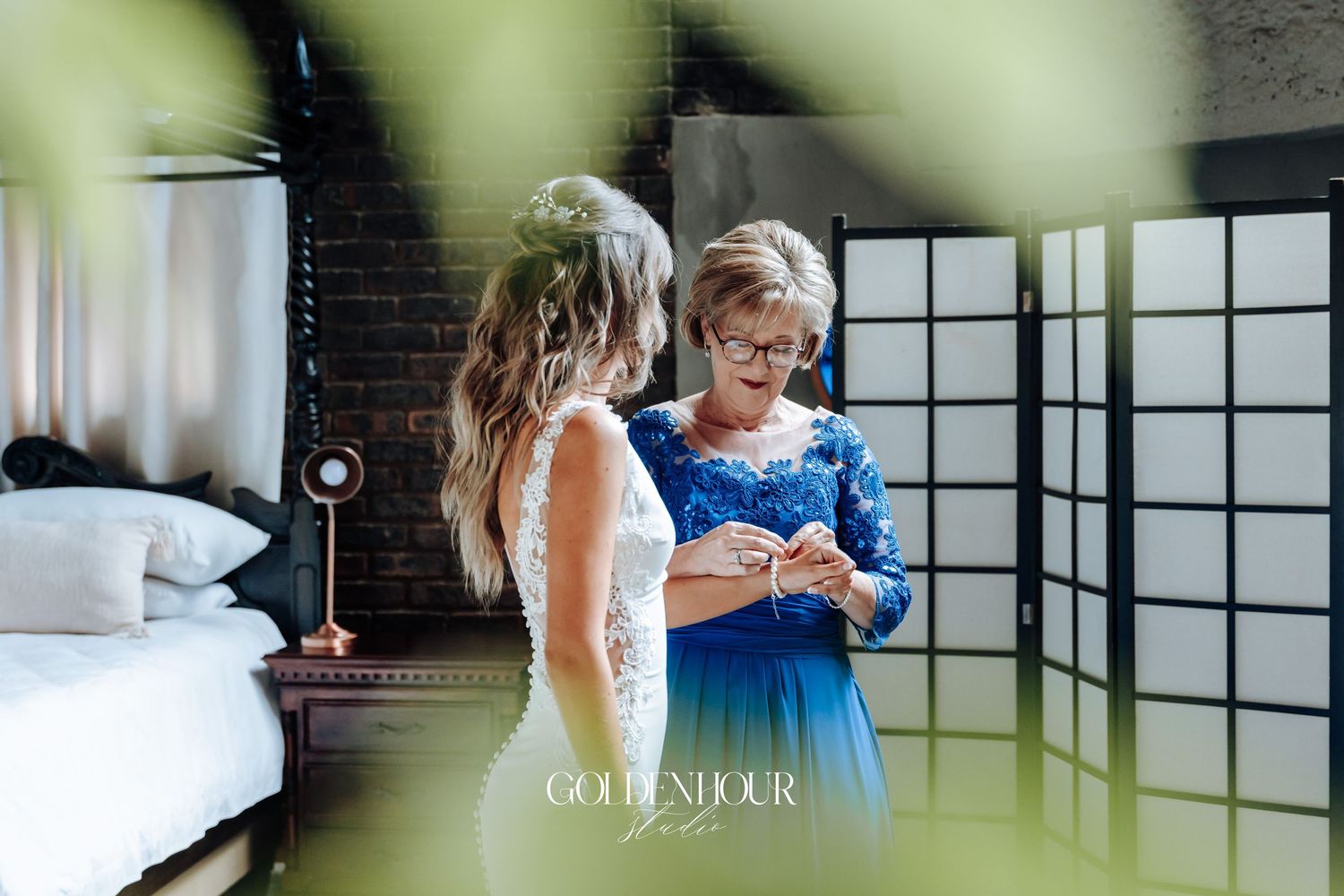 Wedding preparation scene in a sunlit room with window reflections.