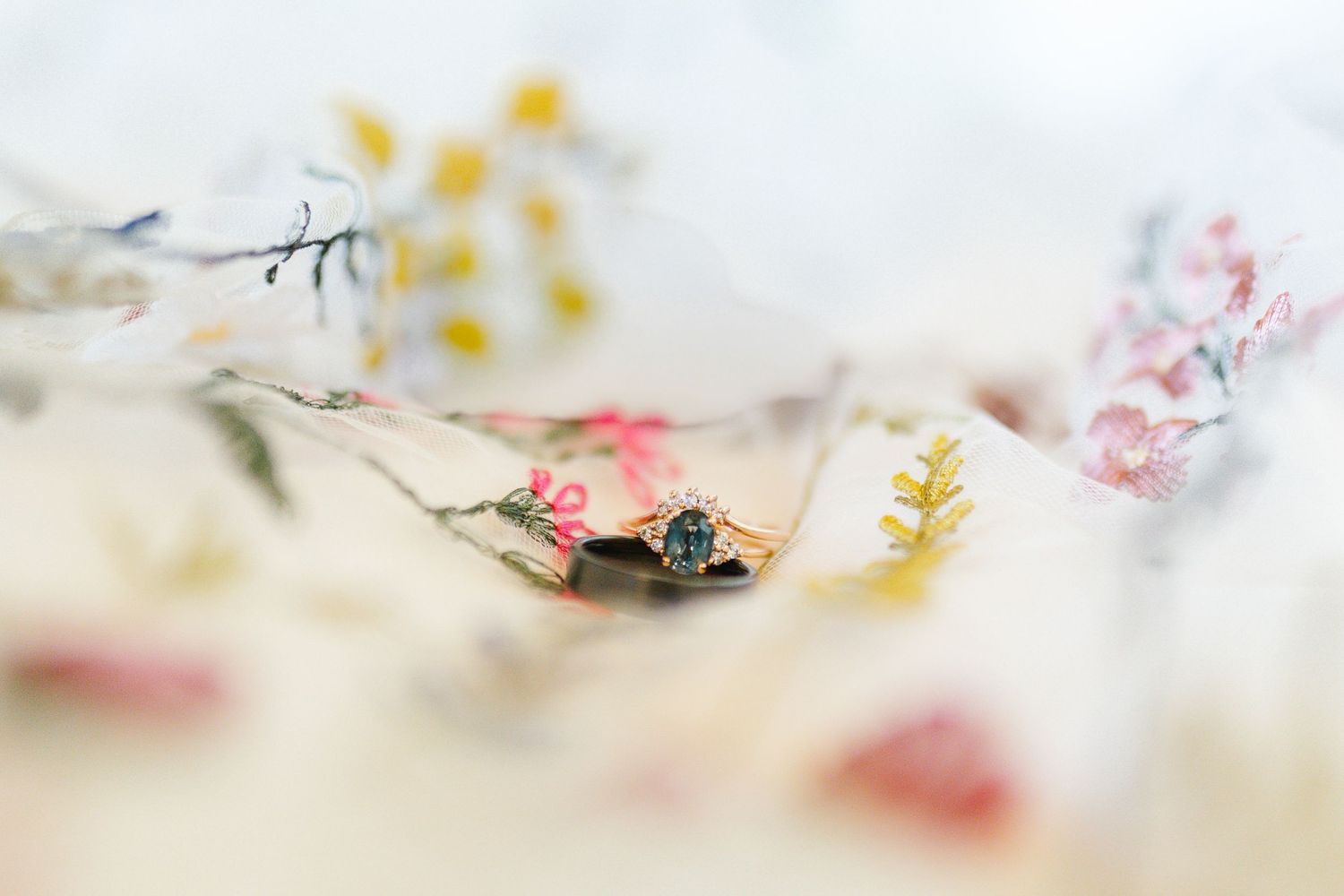 A delicate floral composition with soft pink and yellow petals against a light background creates a dreamy atmosphere.