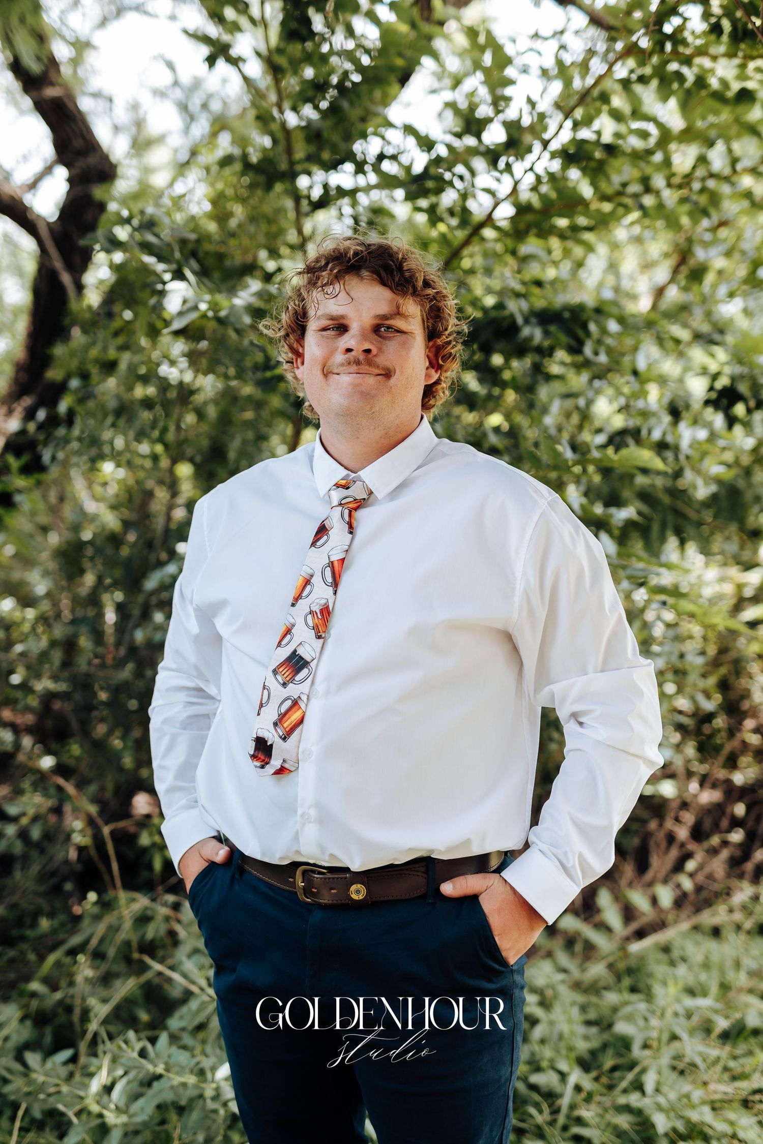 Casual outdoor portrait session in a natural green setting.
