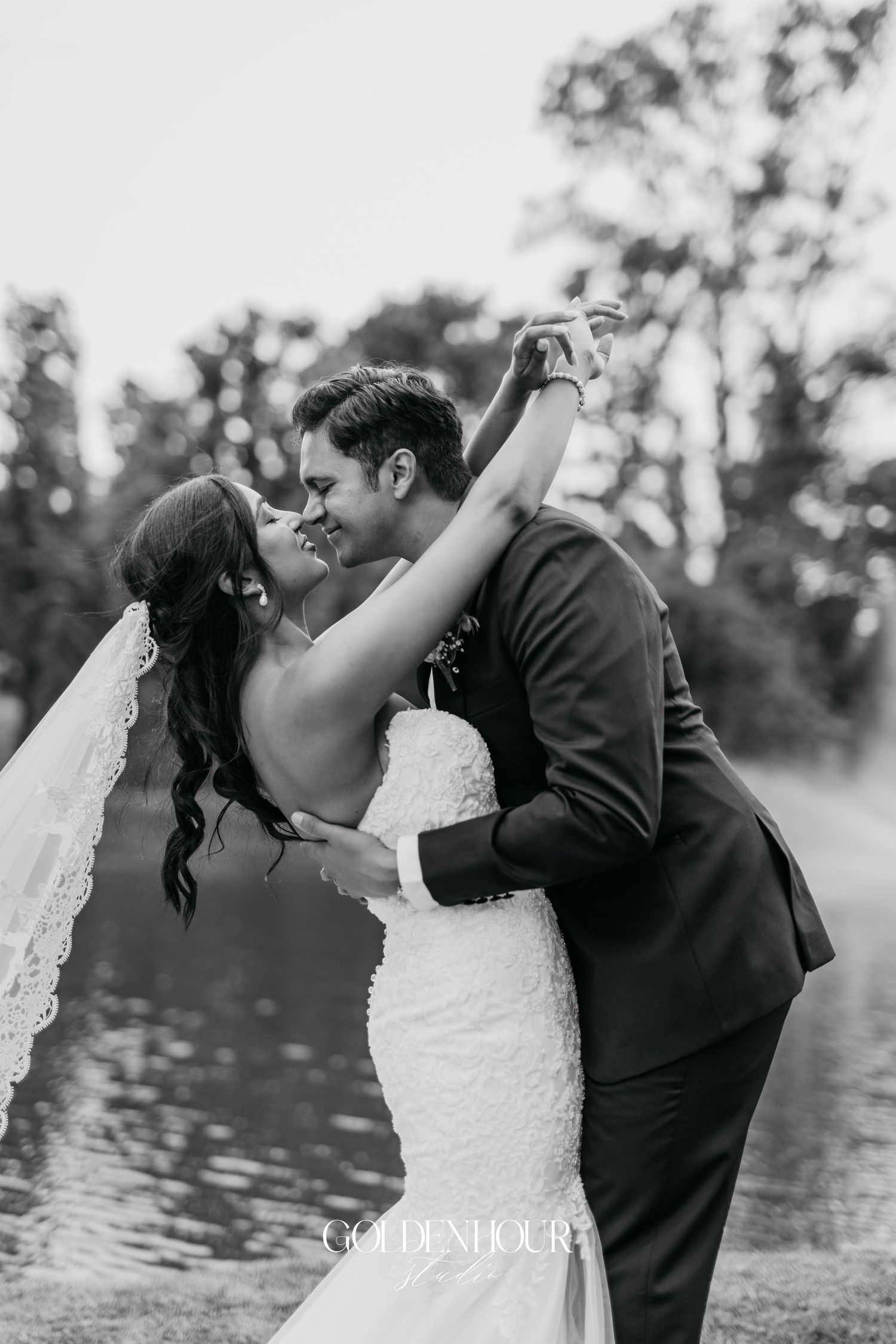 Black and white romantic wedding portrait with couple in intimate embrace.