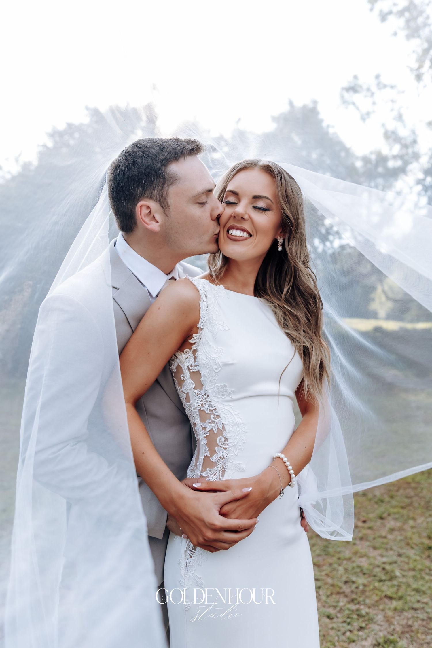 Intimate wedding portraits showing tender moments between newlyweds against a dreamy mountain backdrop.