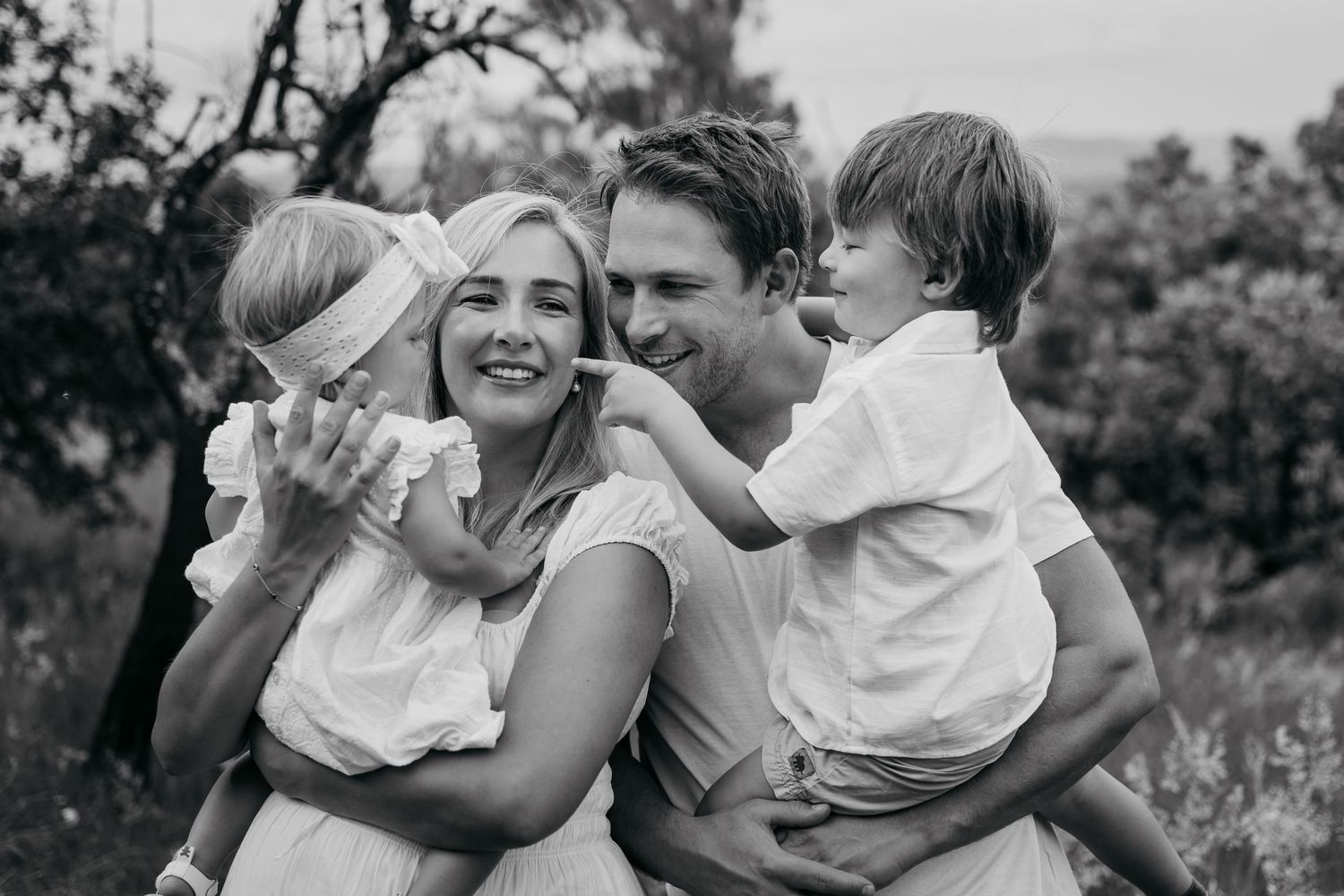 Black and white photo series showing joyful embraces and candid moments between people in an outdoor setting.