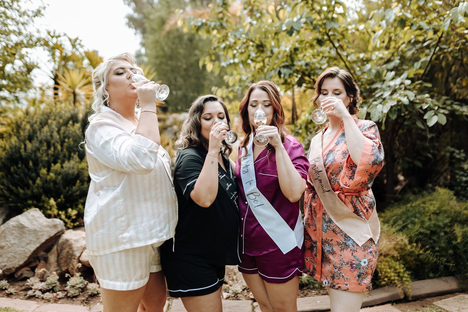 Friends blowing bubbles together during a festive outdoor celebration.