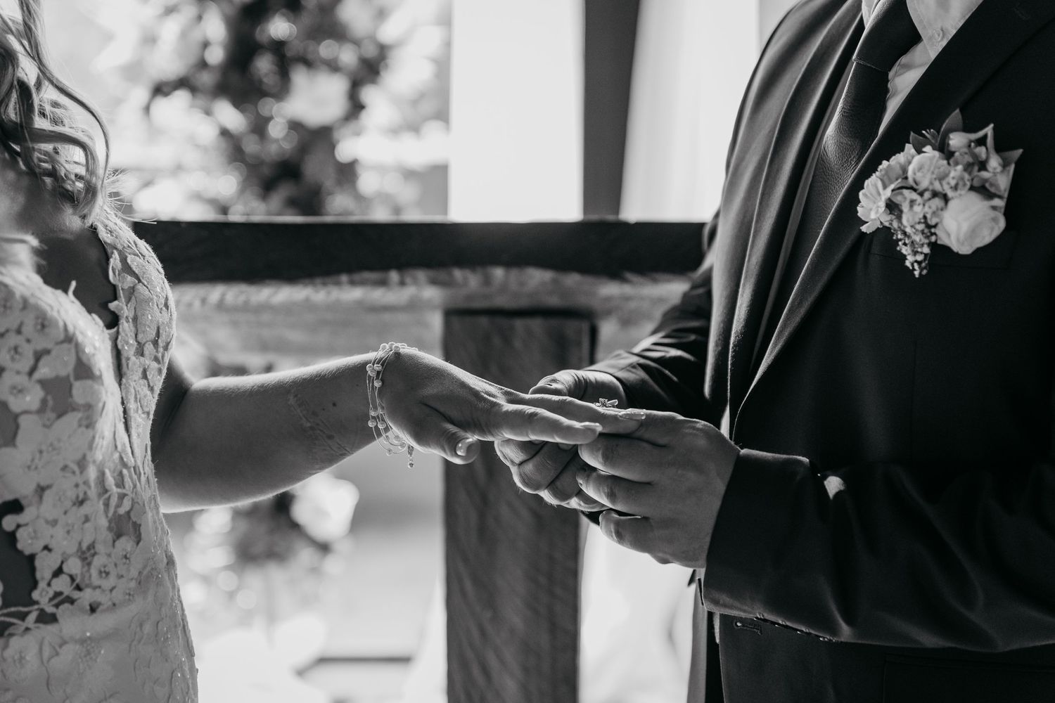 A couple shares an intimate dance moment at their wedding reception with guests watching in the background.