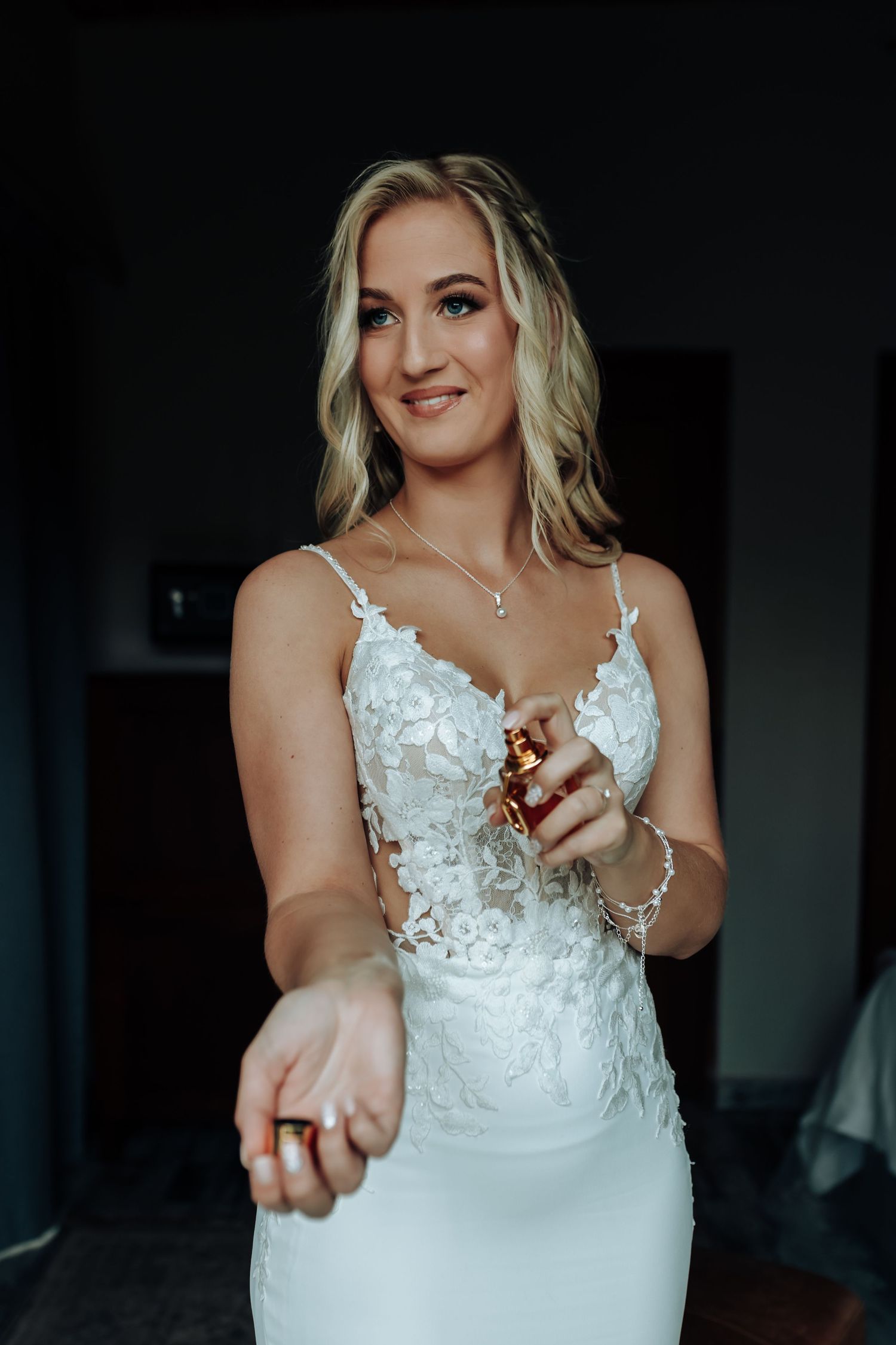 Close-up sequence showing details of a white lace wedding dress with delicate floral appliques and straps.
