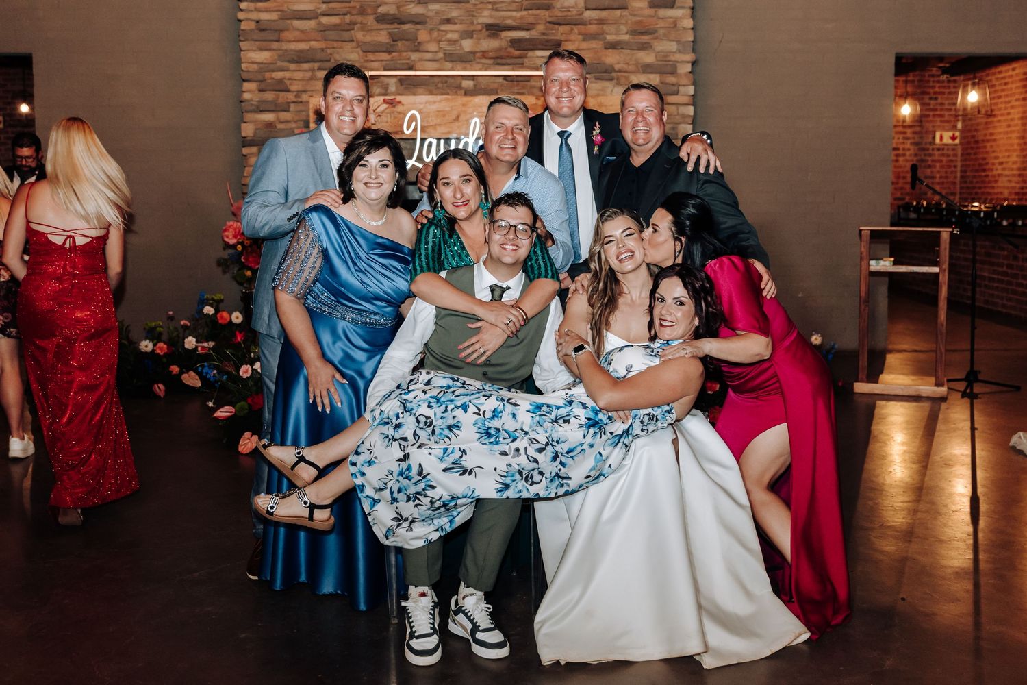 Wedding guests gathered for group photos during the reception celebration.
