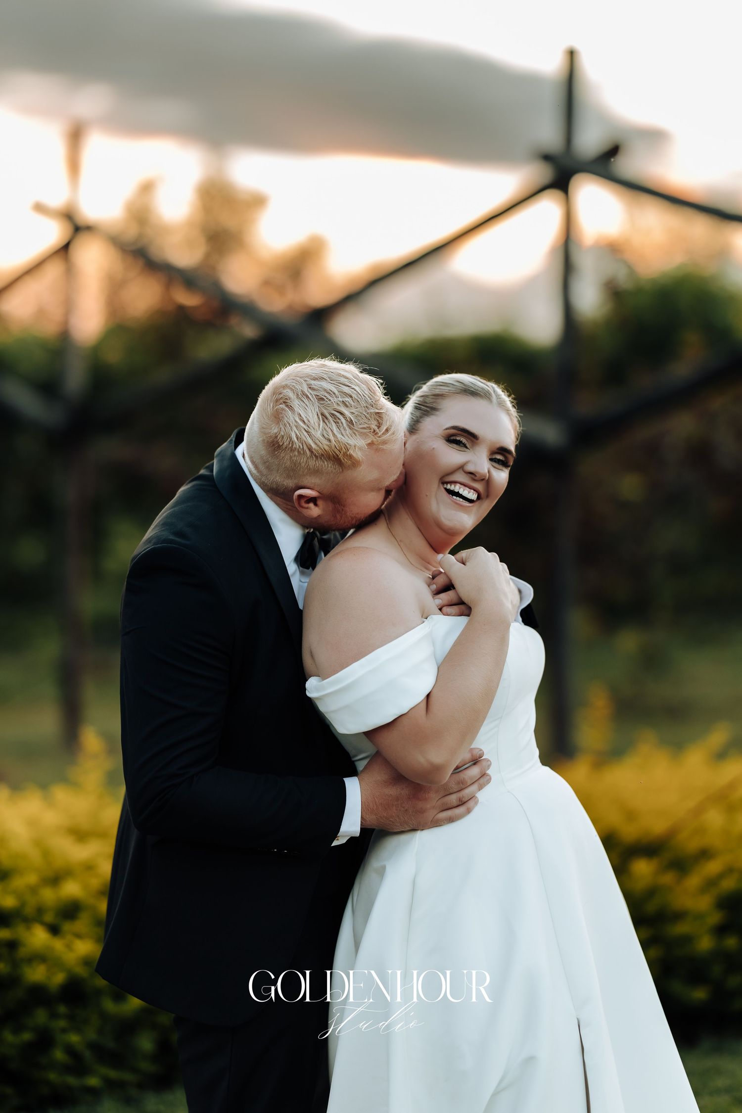 Romantic sunset wedding photo sequence shows couple in elegant white dress and tuxedo embracing in garden setting.