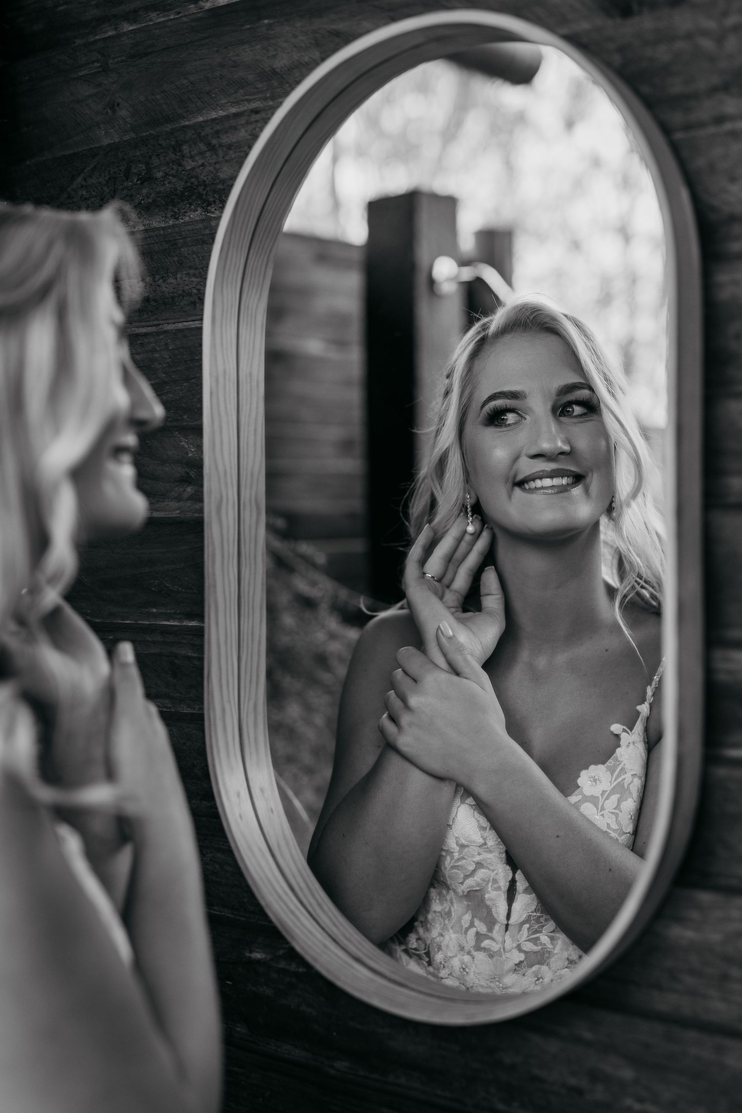 A series of black and white mirror reflections showing a person in a lace wedding dress preparing for a special occasion.