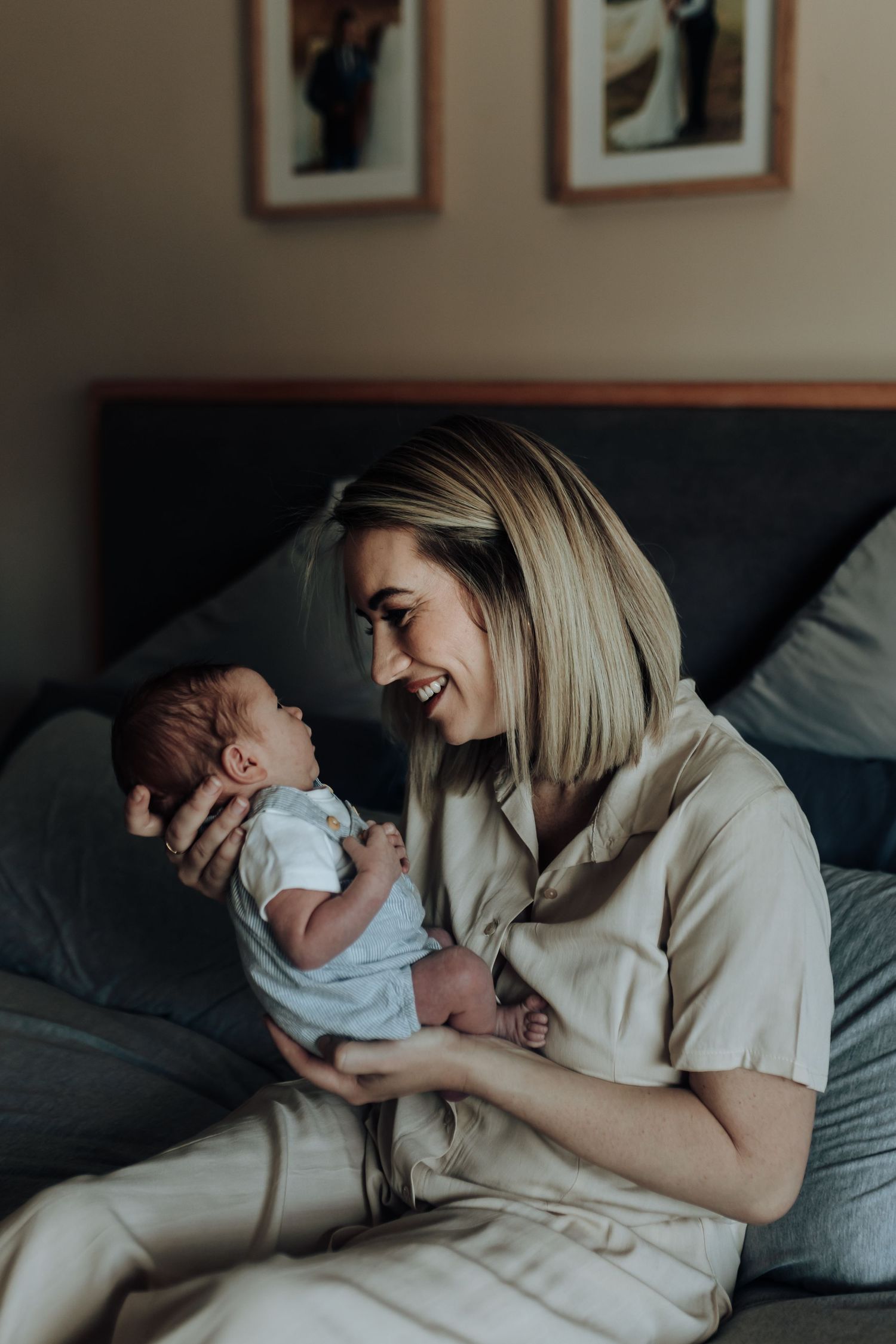 A heartwarming sequence shows tender moments between a parent and baby resting together on a bed.