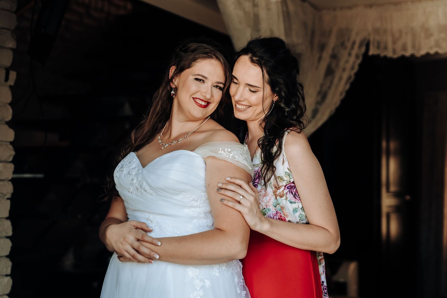 Two people share an intimate embrace during wedding preparations.
