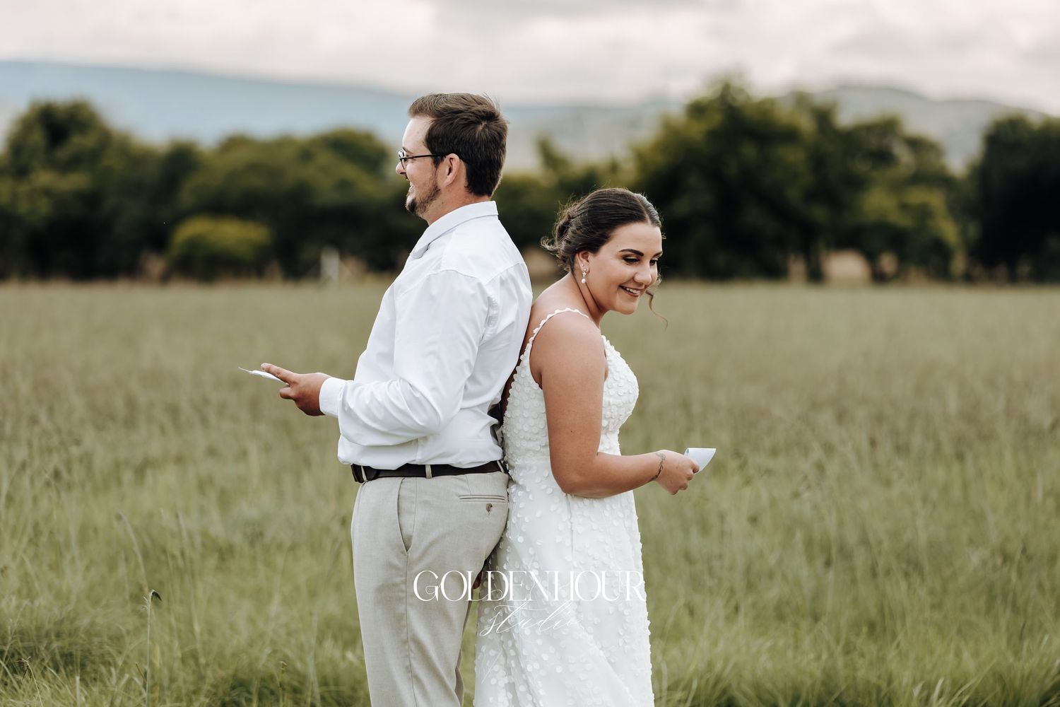 Wedding couple walking through a serene meadow on their special day.