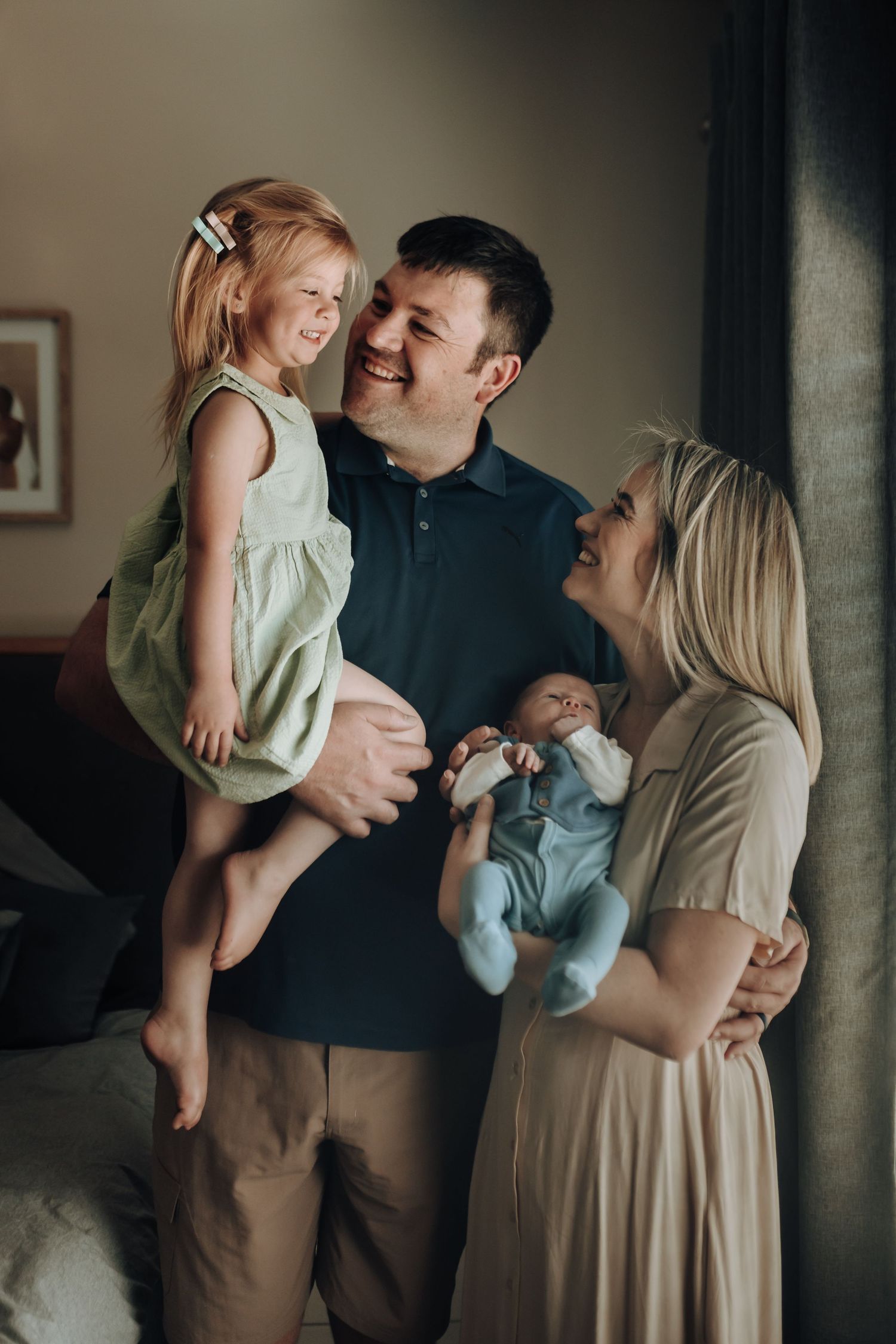 Series of five lifestyle photos showing intimate family moments in muted tones against neutral backgrounds.