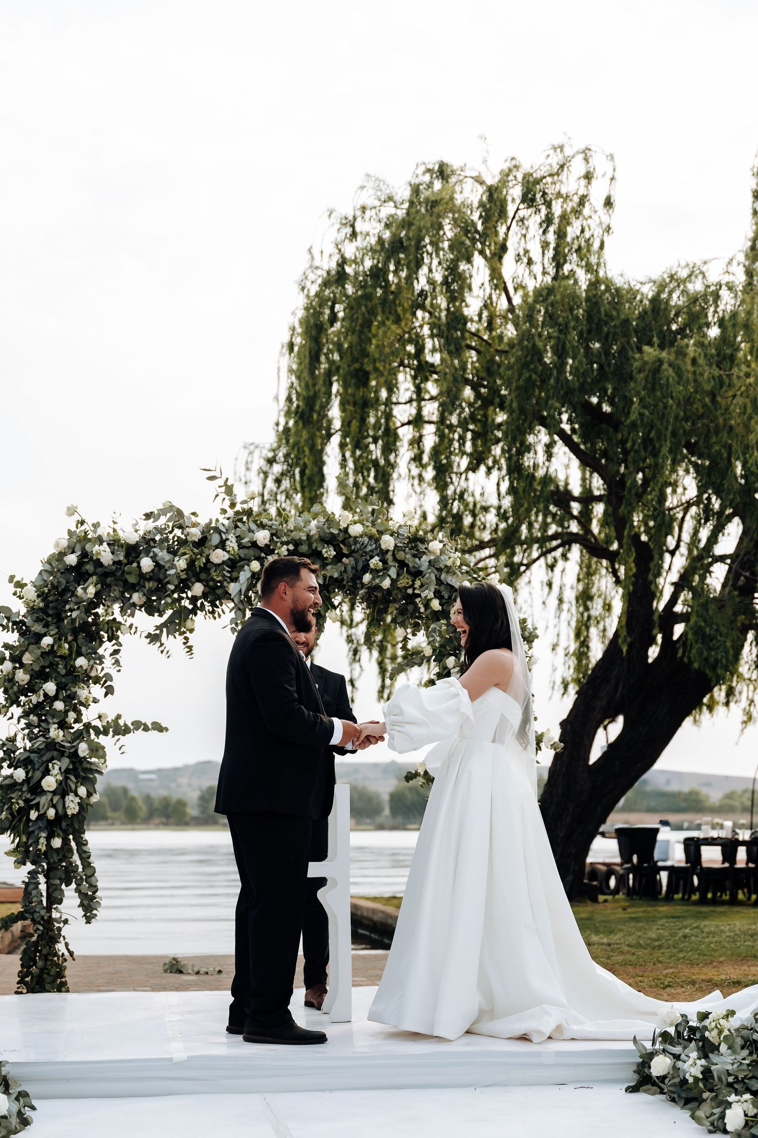 A romantic wedding proposal sequence under a willow tree by the water at sunset.