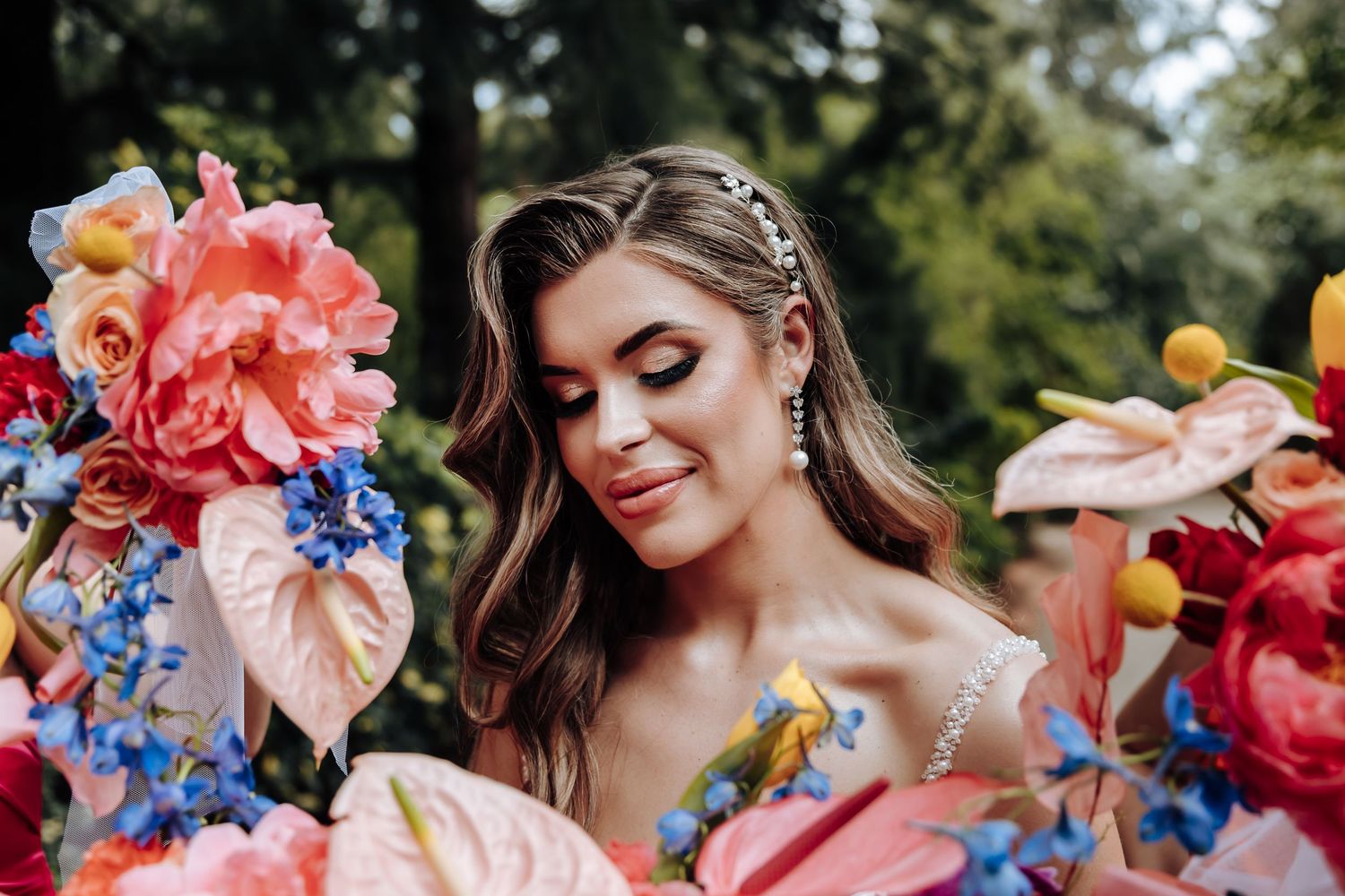 A collection of colorful floral bouquets with coral and blue flowers arranged for a wedding celebration.