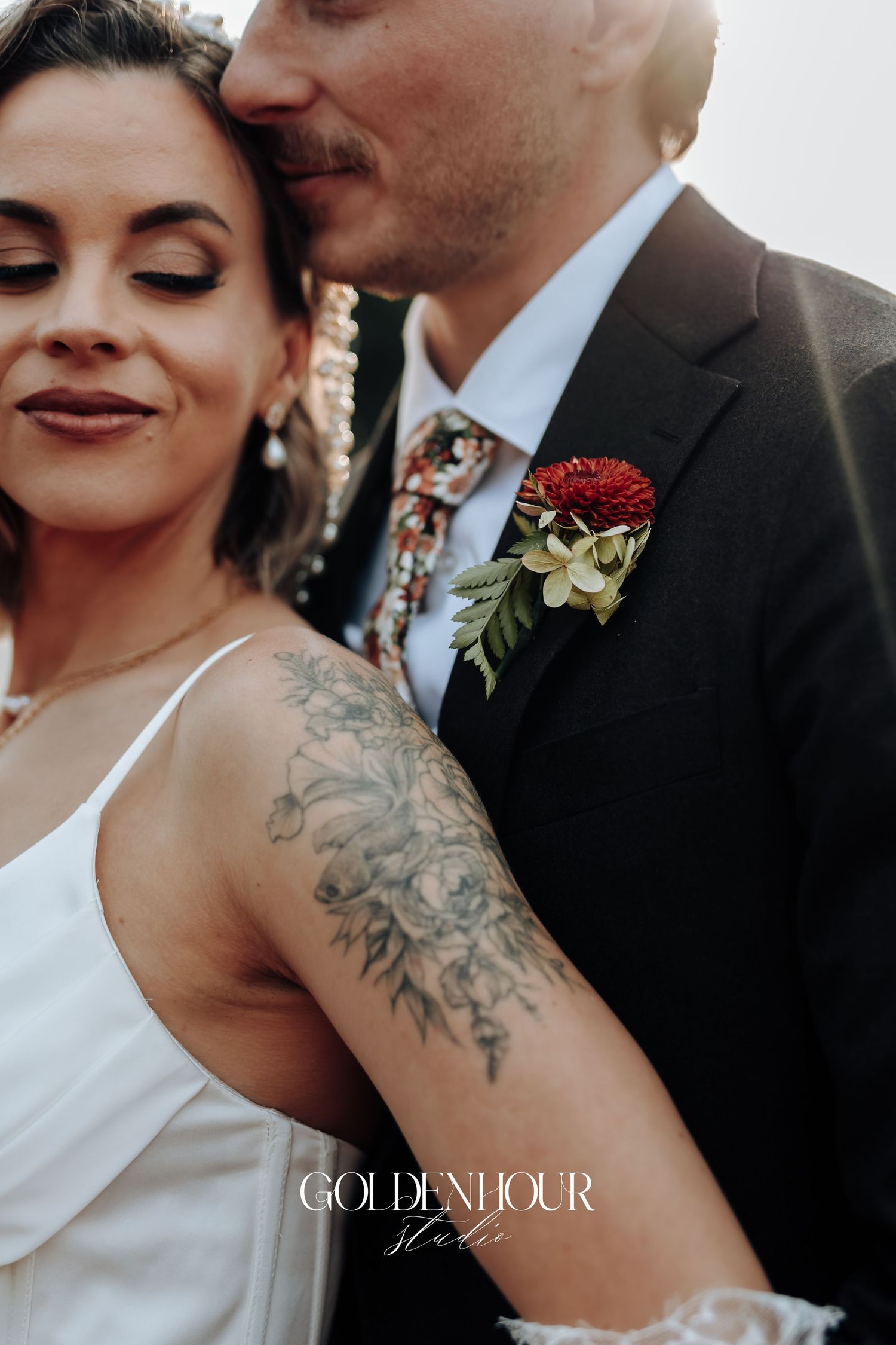 Close-up details of floral tattoo and intimate wedding moment.