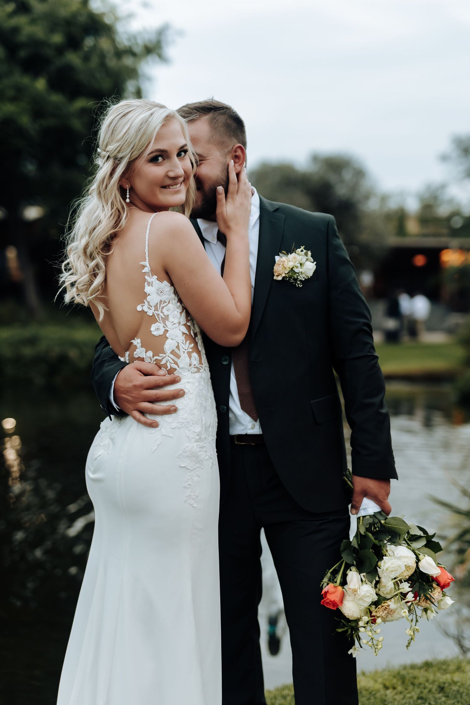 A romantic wedding couple shares intimate moments by a lake in a series of black and white photos.