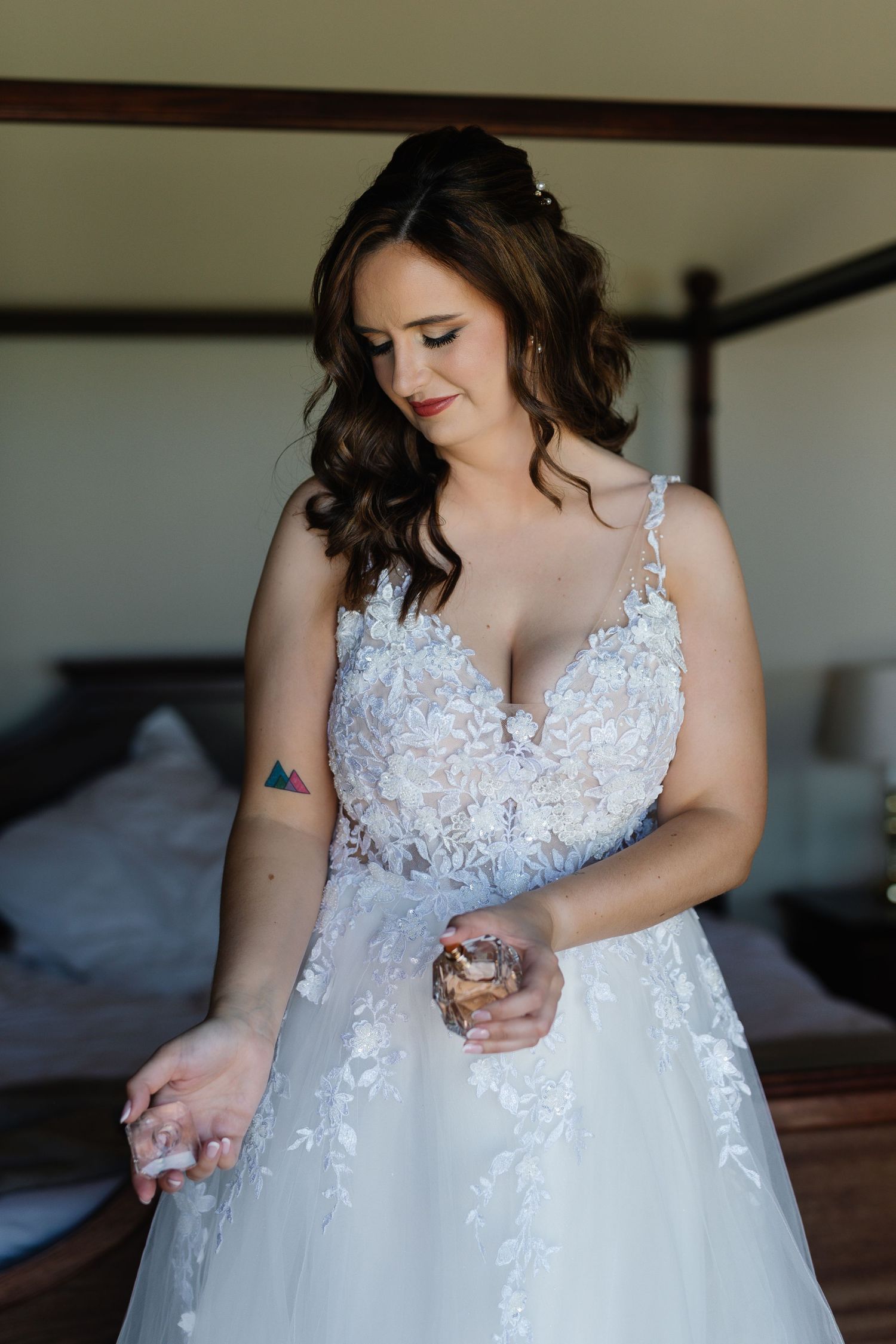 A close-up detail shot shows delicate white lace appliques and beading on a wedding dress bodice.