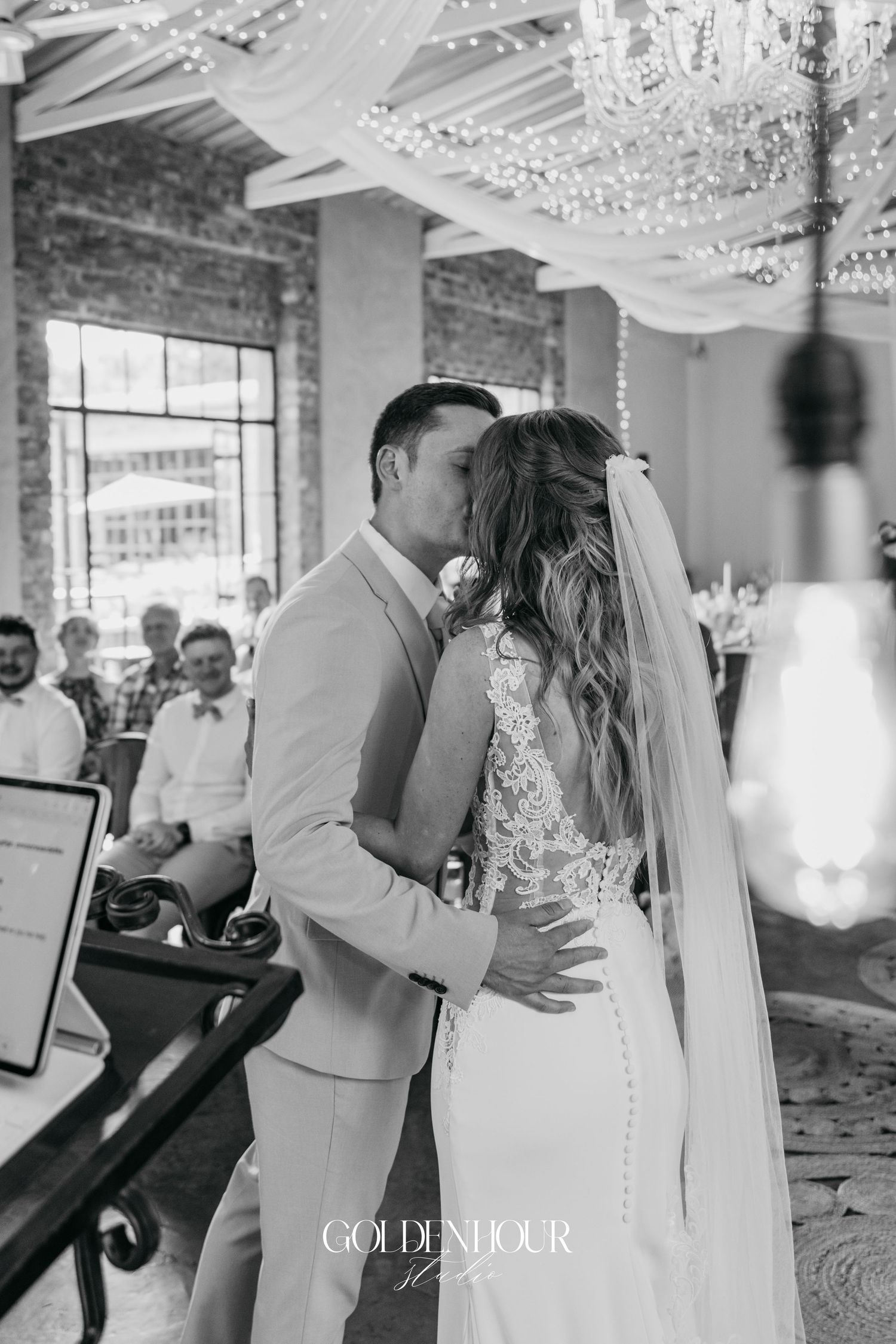 Romantic first dance moments captured under crystal chandeliers in an elegant reception venue.