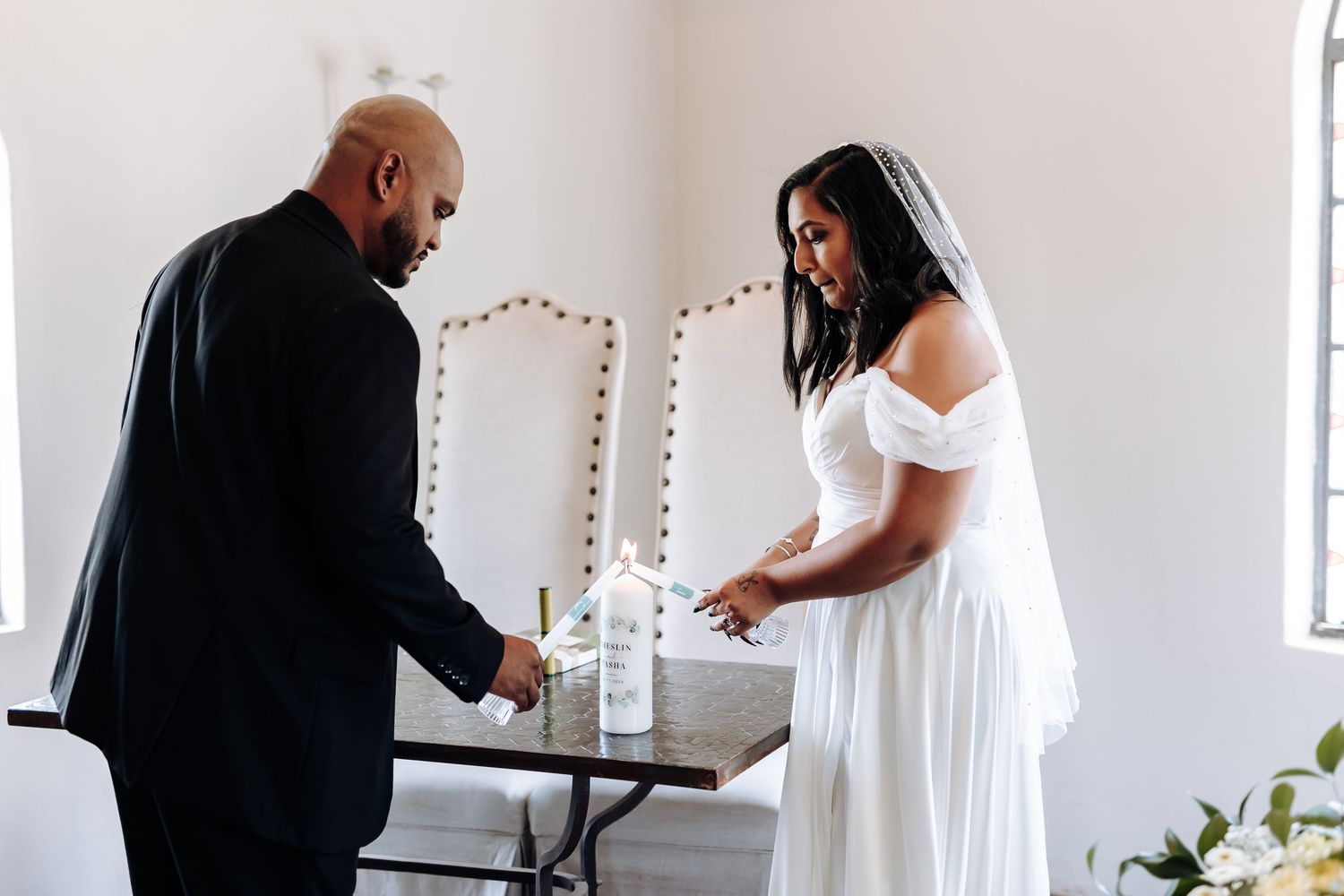 A couple participates in a unity ceremony during their wedding.