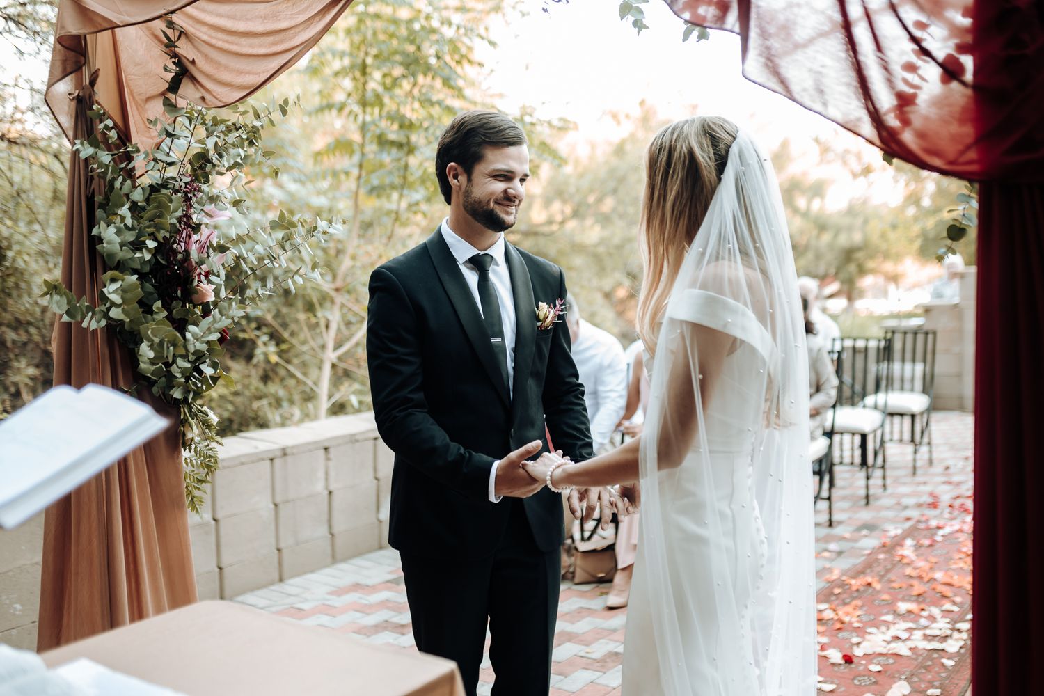Close-up of rings being exchanged during a wedding ceremony.