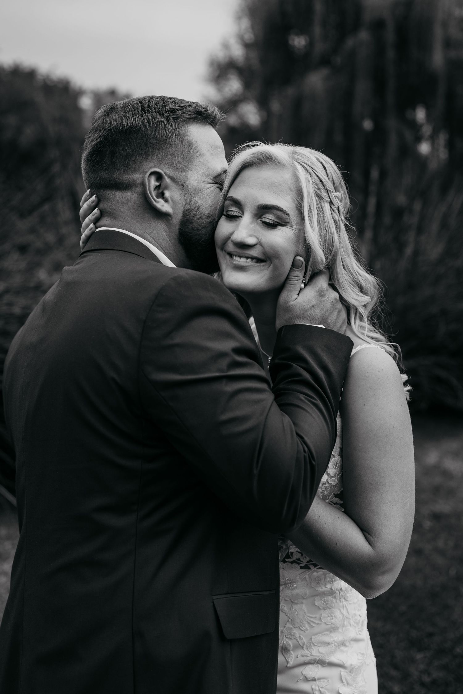 A romantic black and white photo sequence shows a couple in wedding attire sharing tender moments together outdoors.