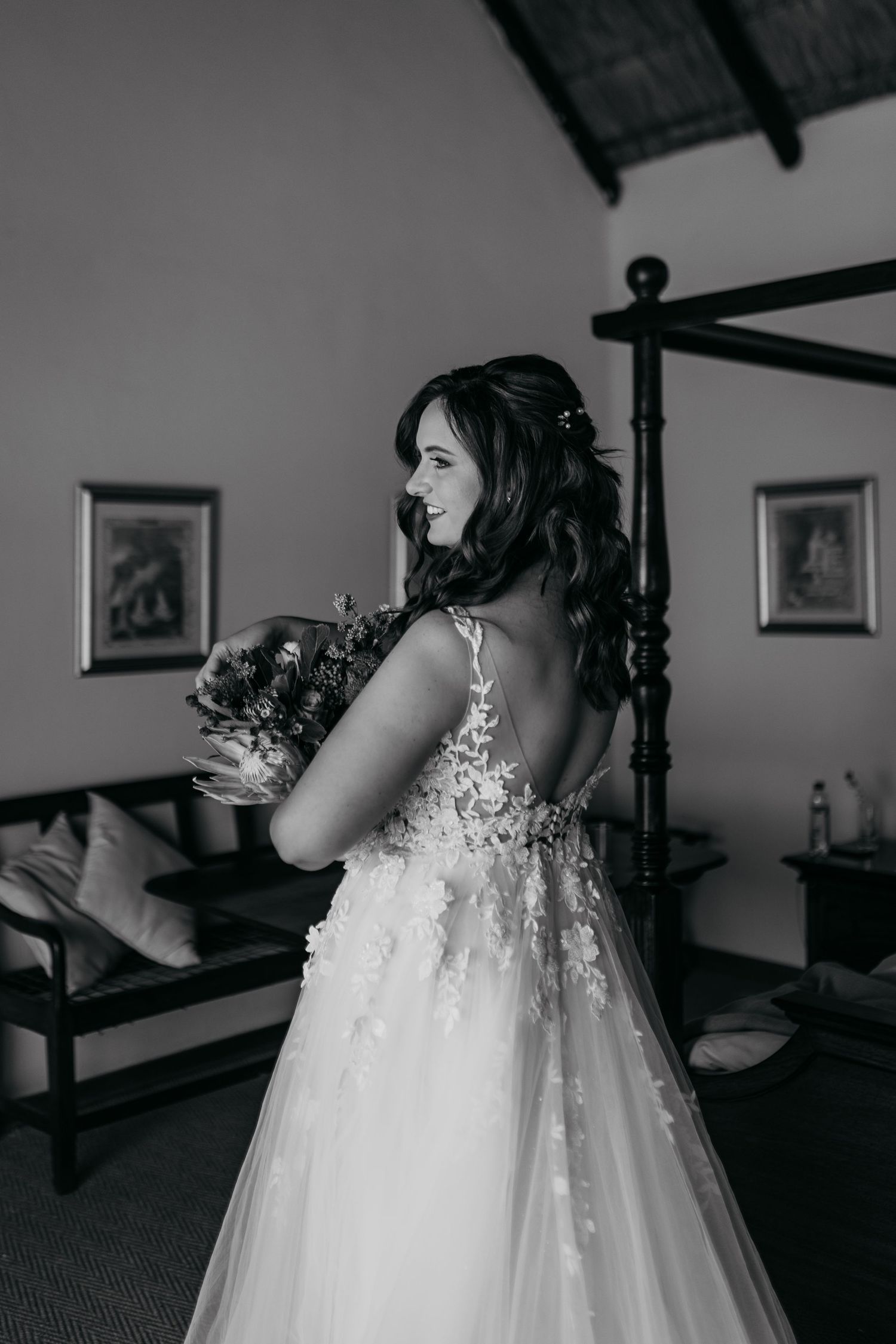 A bride in a flowing white dress with lace details is shown in a series of black and white photographs.